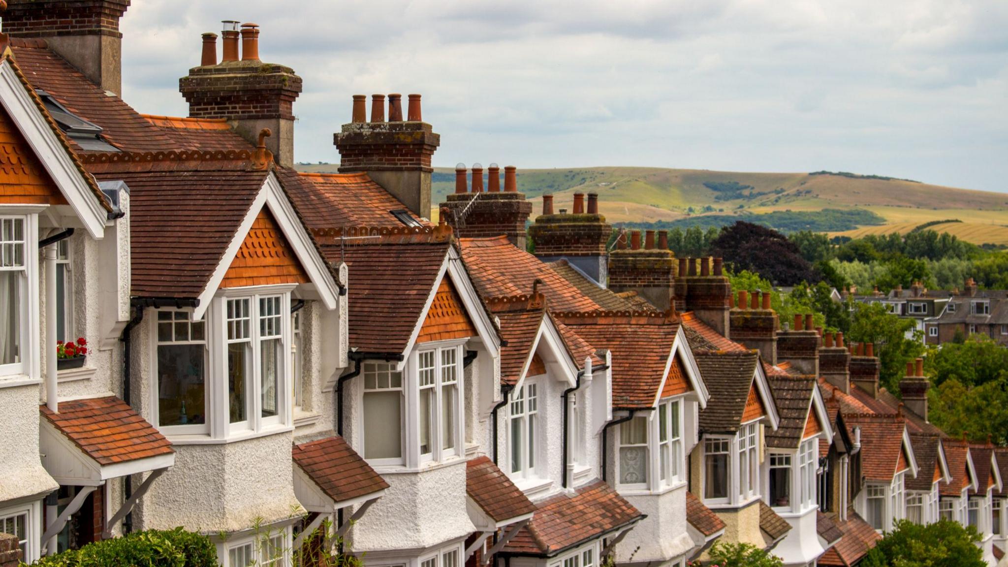 Rows of houses with hills visible behind
