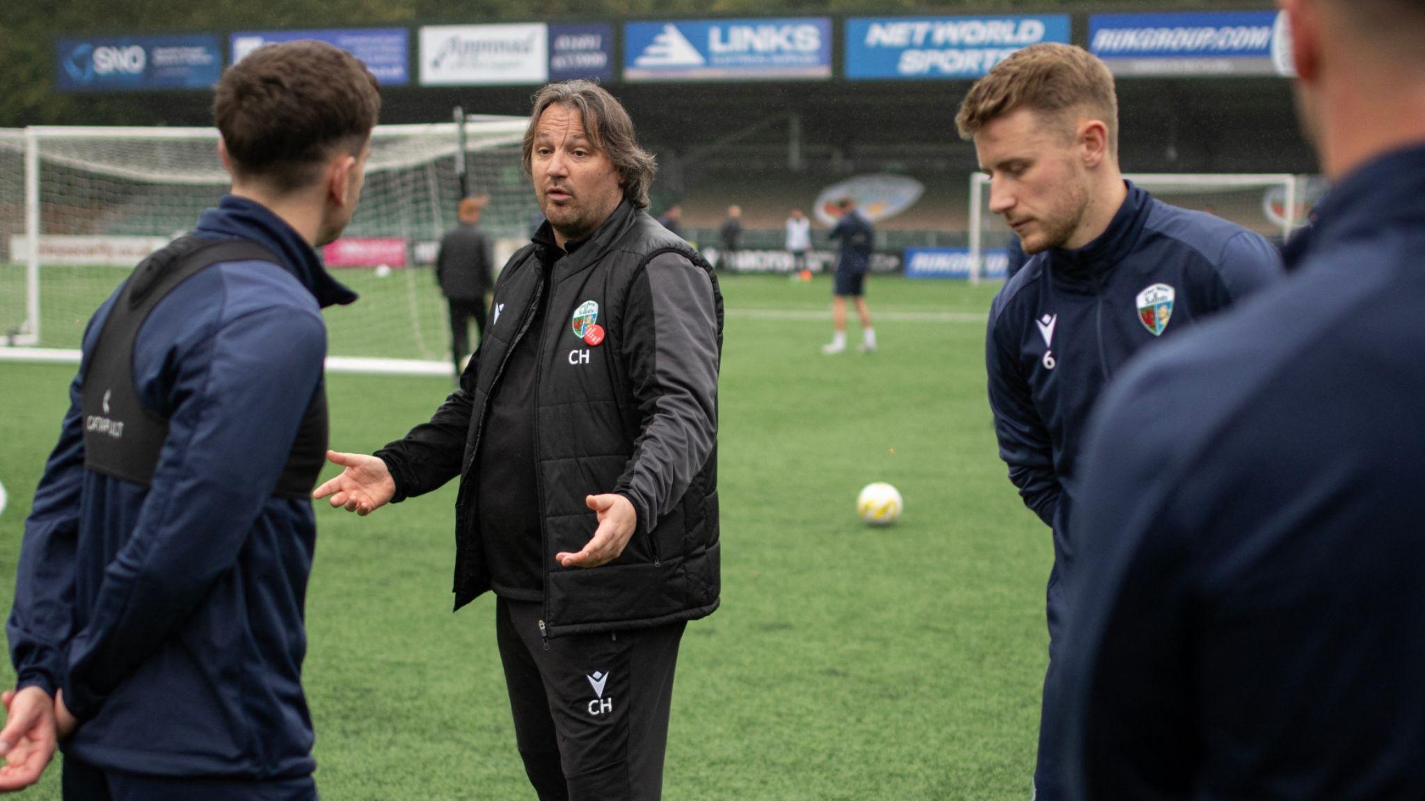 TNS manager Craig Harrison talks to players