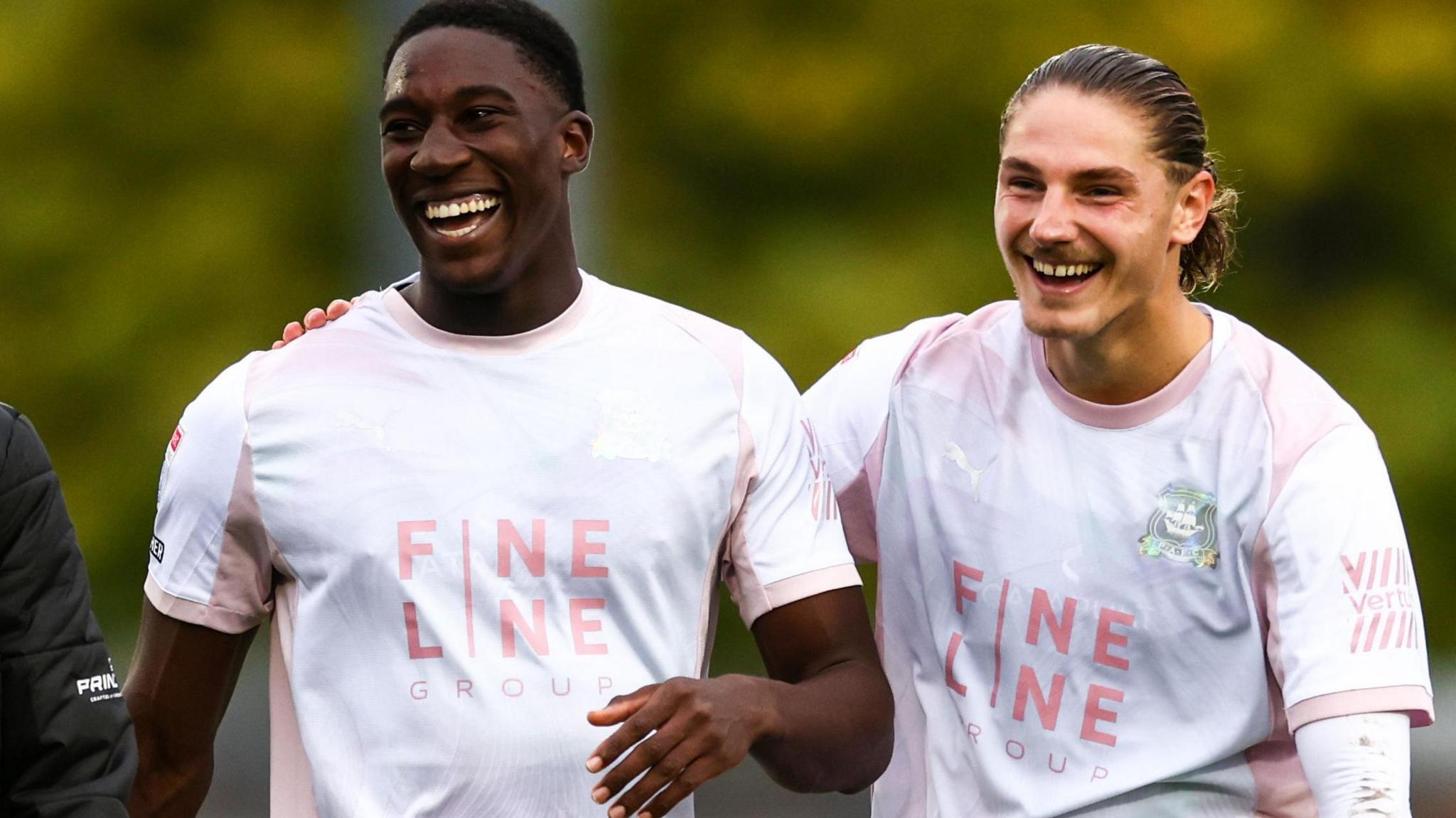 Bim Pepple laughs with Lorent Tolaj (right)