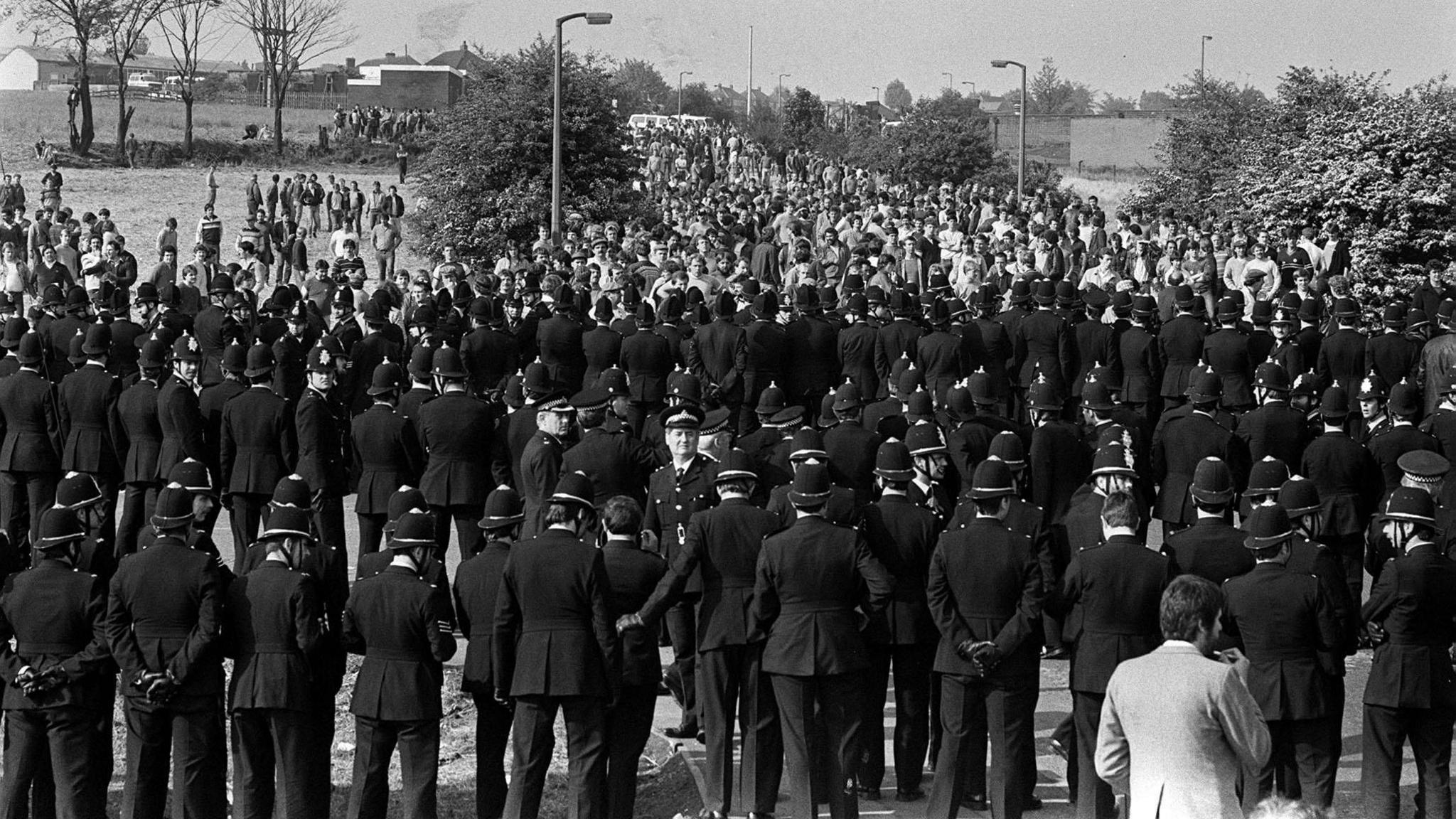 File photo dated 31/05/84 of police facing pickets as they arrive on the hill heading to the Orgreave Coking Plant near Rotherham during the miners dispute.
