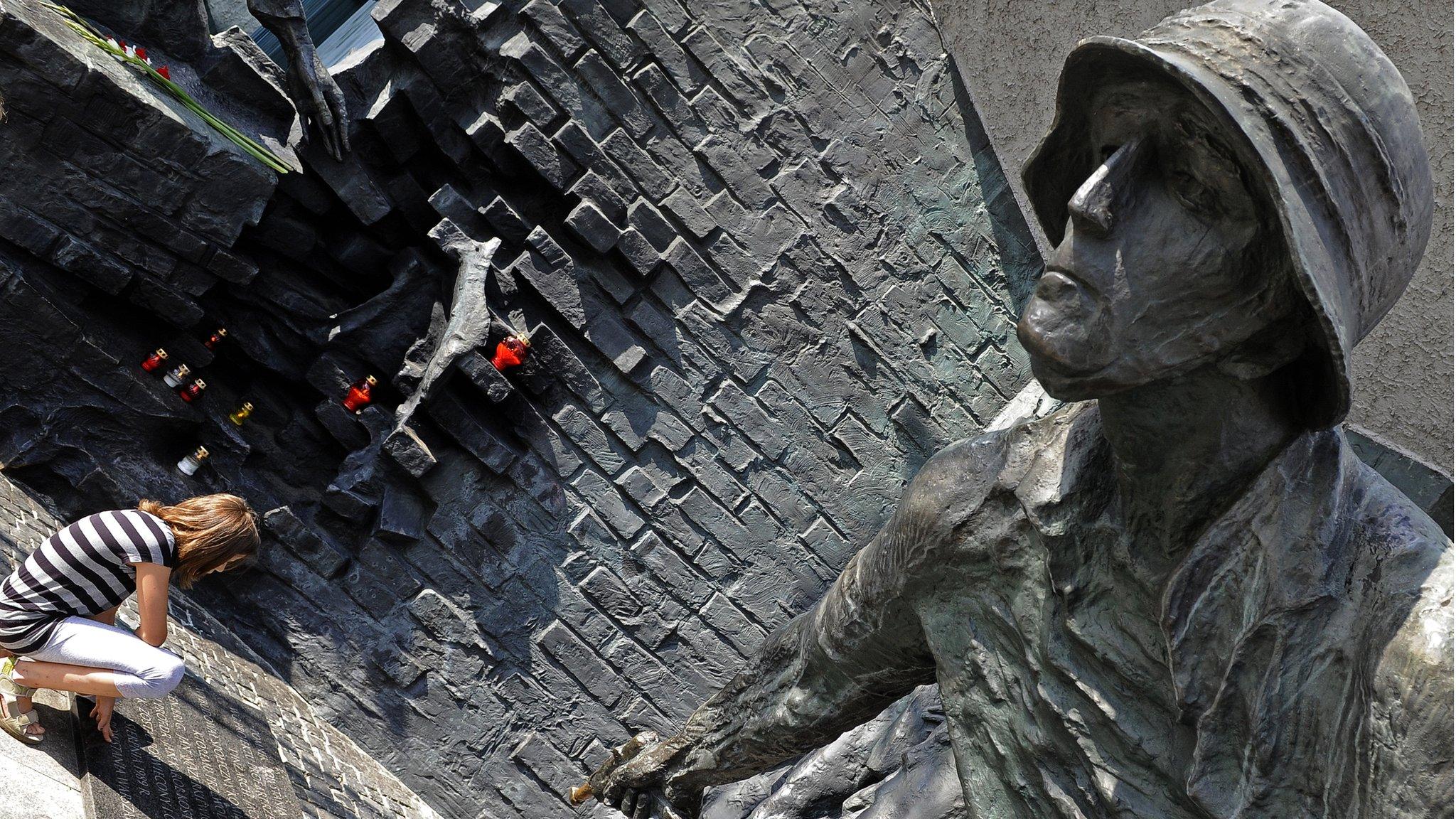 Woman at a Warsaw monument commemorating the Polish who fought German occupation troops during the Warsaw Uprising in World War II