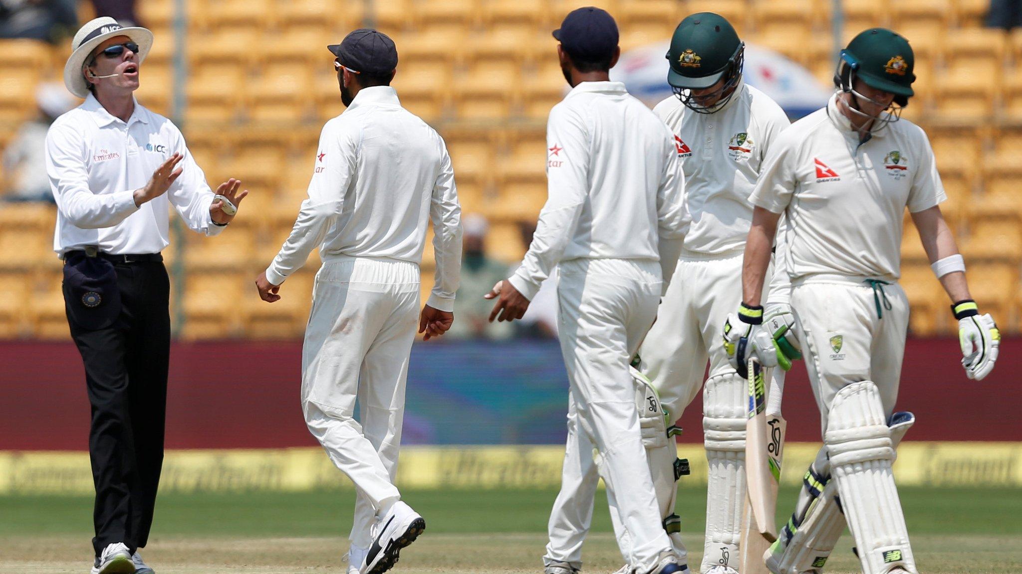 India captain Virat Kohli speaks to umpire Nigel Llong after Steve Smith's dismissal