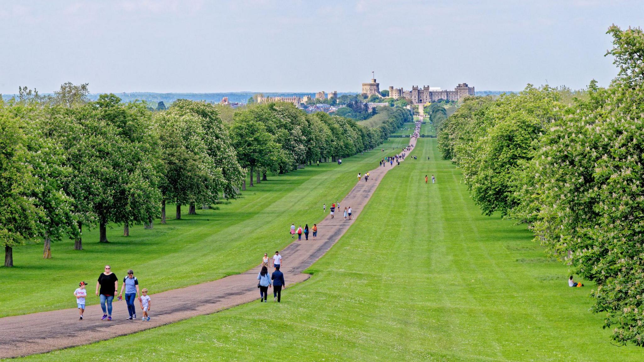 Windsor Castle viewed down the Long Walk with people enjoying the view and warm summer sun in Windsor on 31 May 2021.