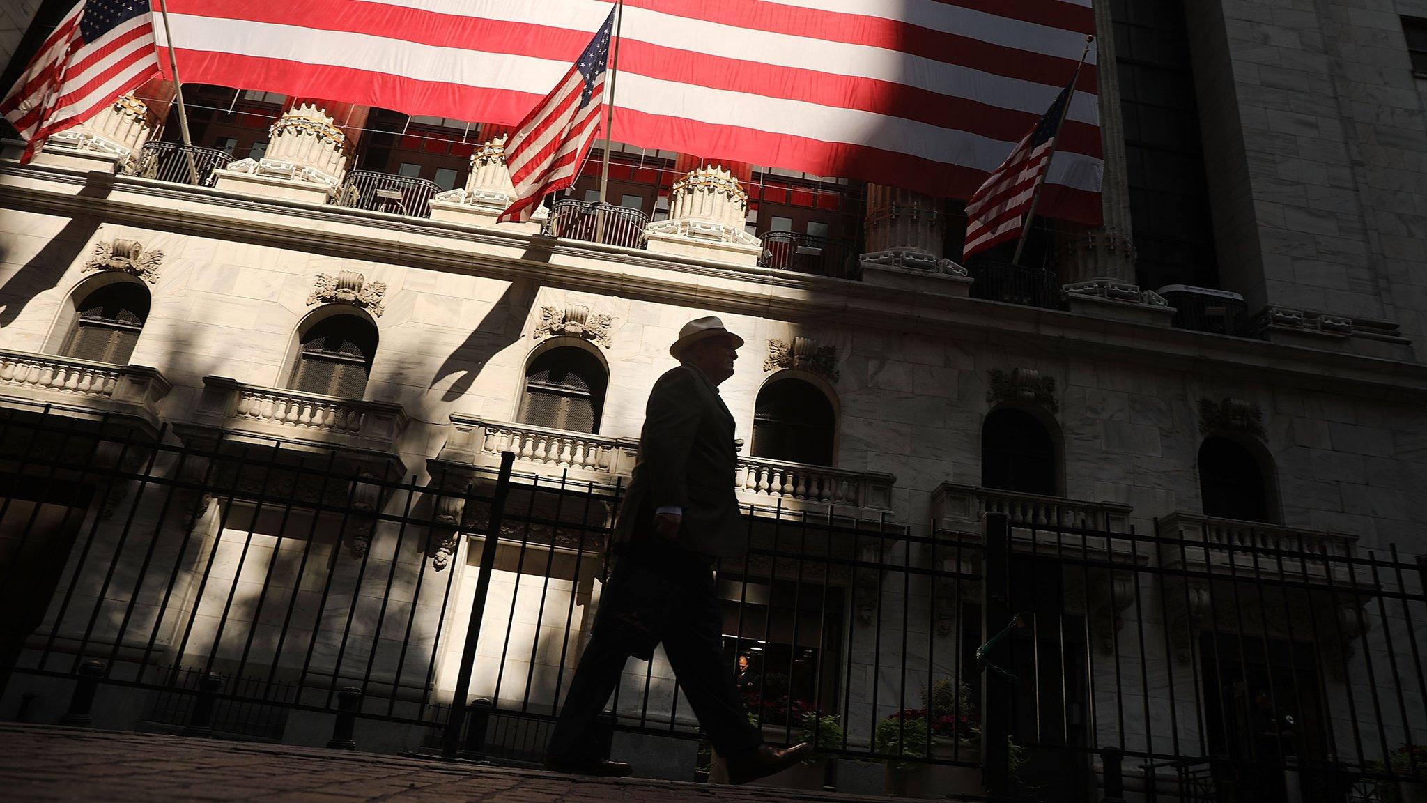 A man walks by the New York Stock Exchange (NYSE) on July 12, 2018 in New York City.