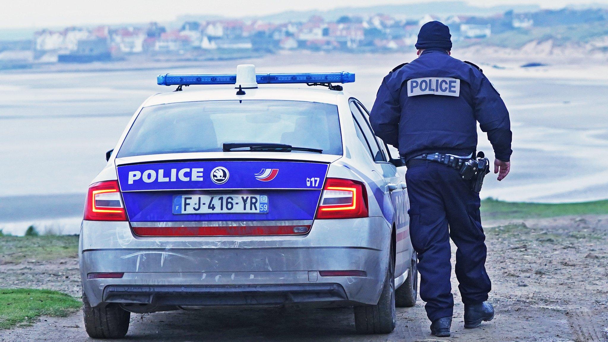 A French police officer looks out over the Channel