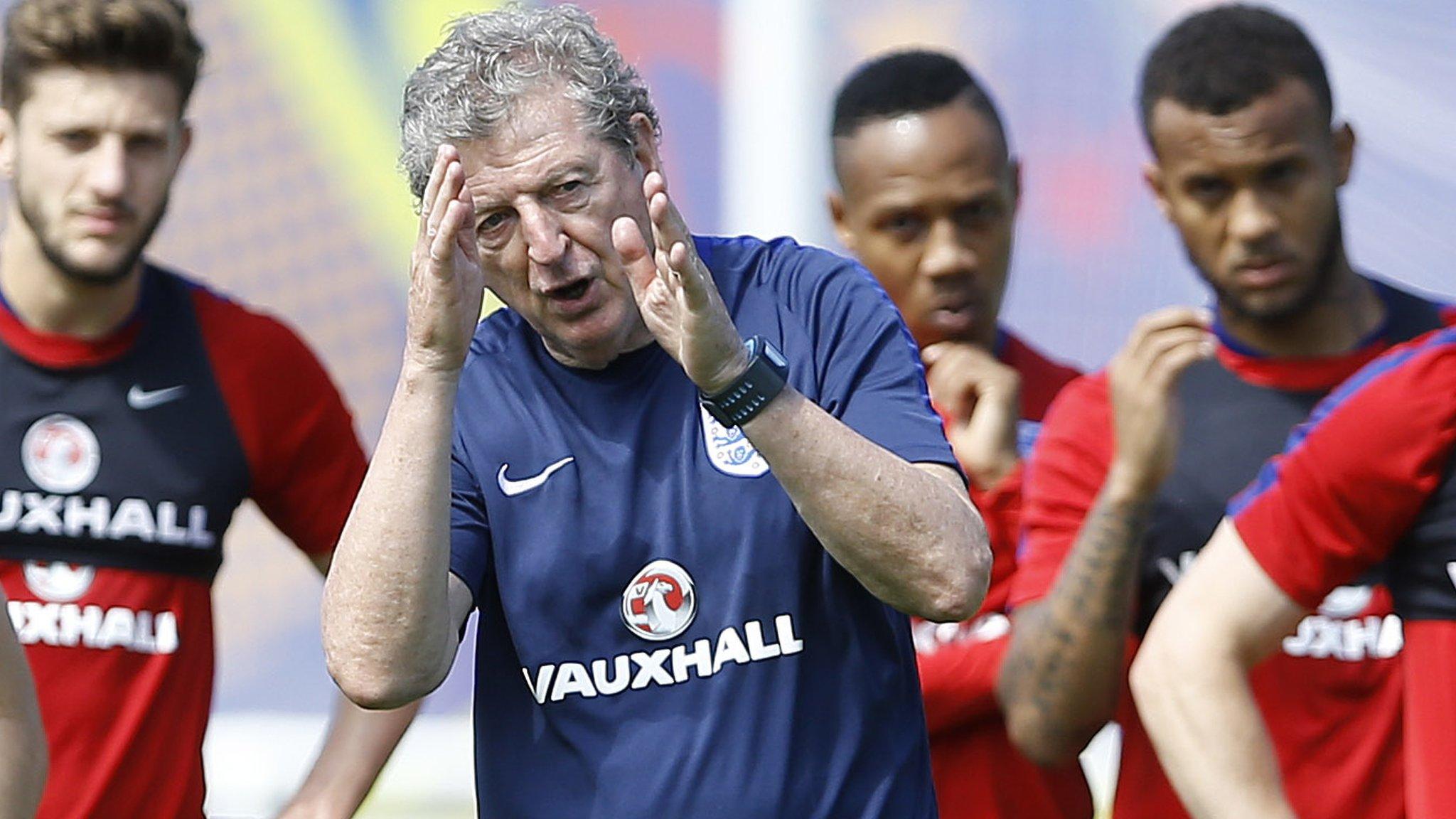 England boss Roy Hodgson speaks with players during a training session in Chantilly, France