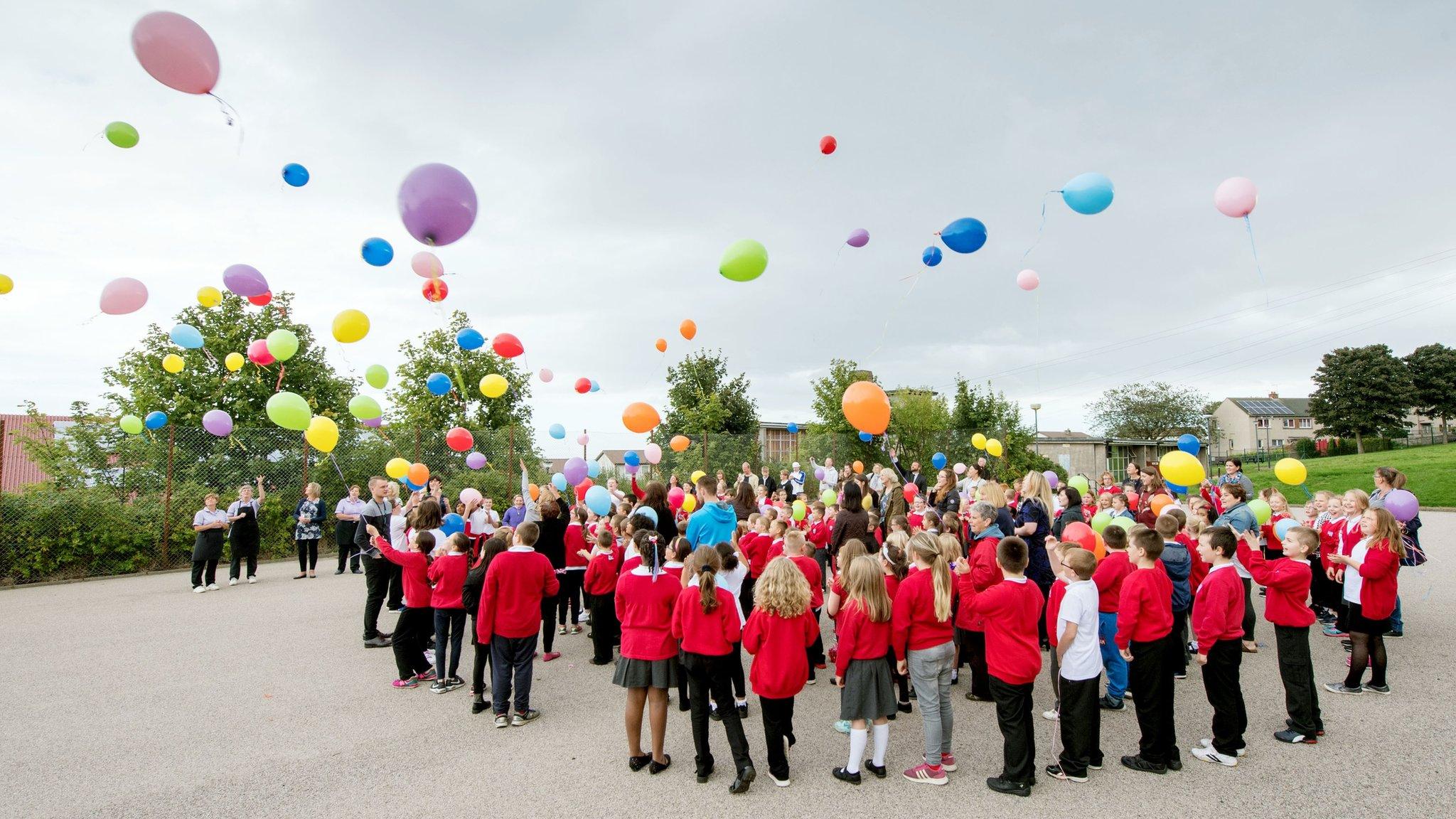 Pupils releasing balloons