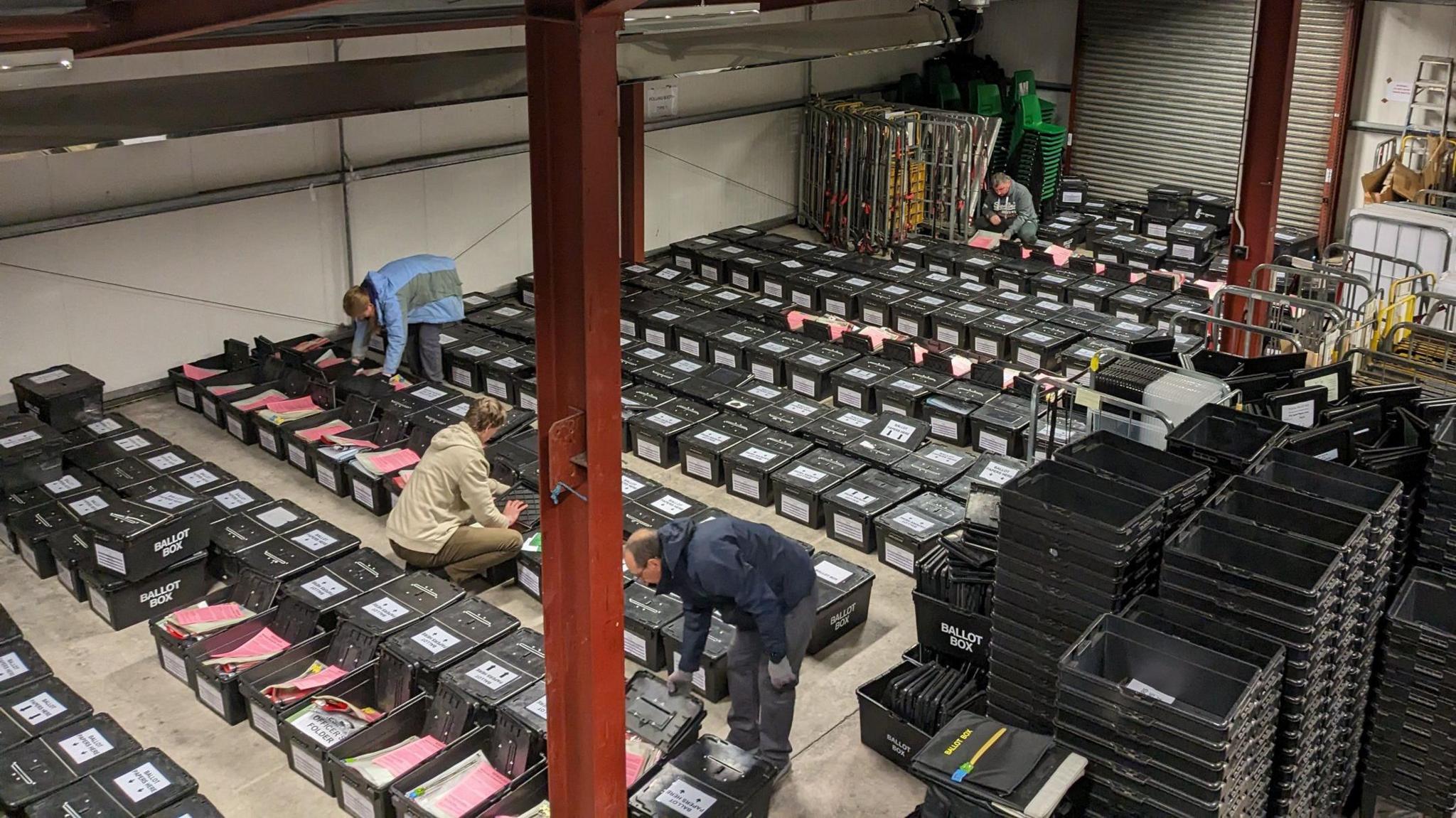 Ballot boxes being arranged by staff 