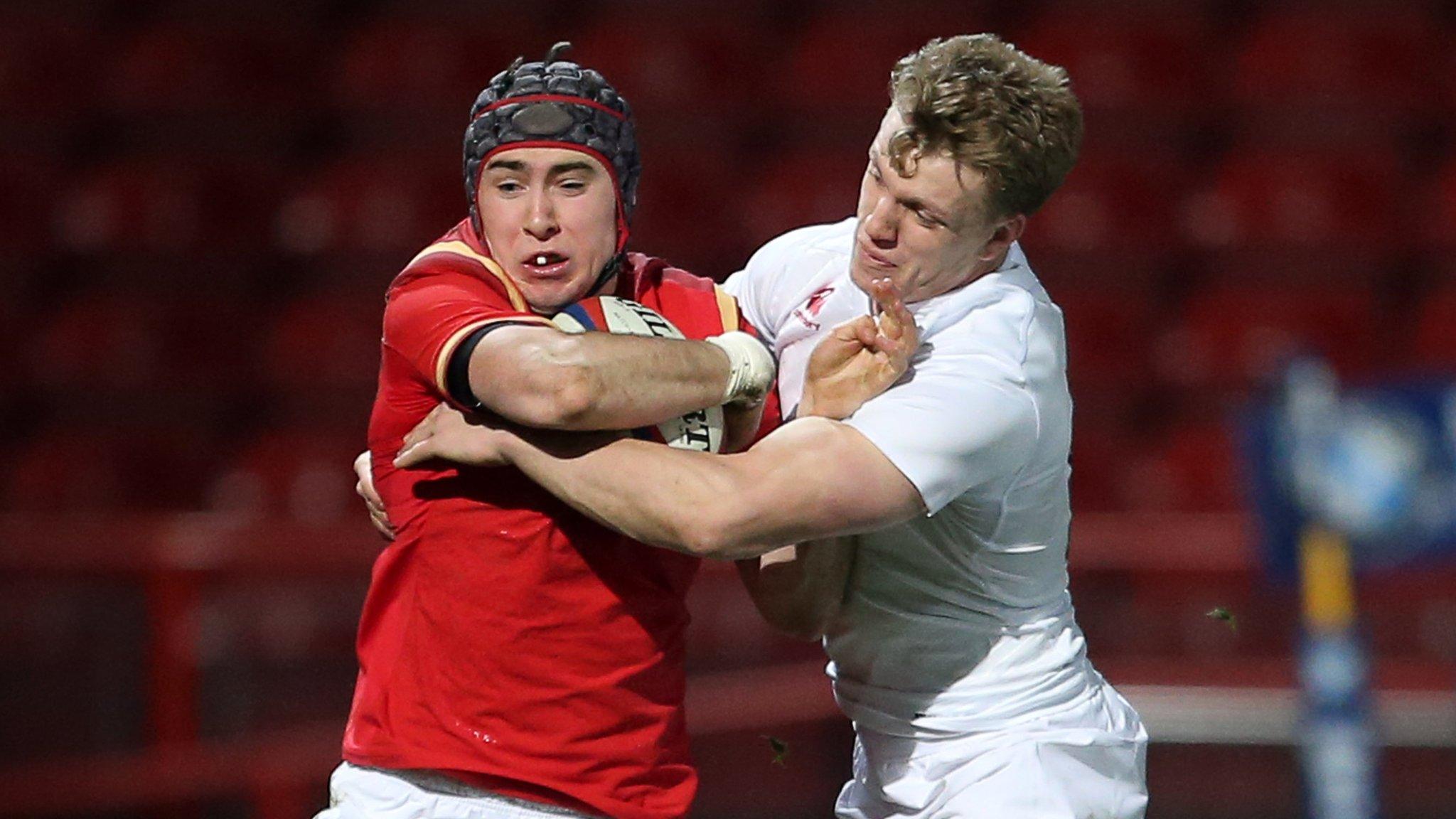Wales' Rhun Williams is tackled by Ollie Thorley