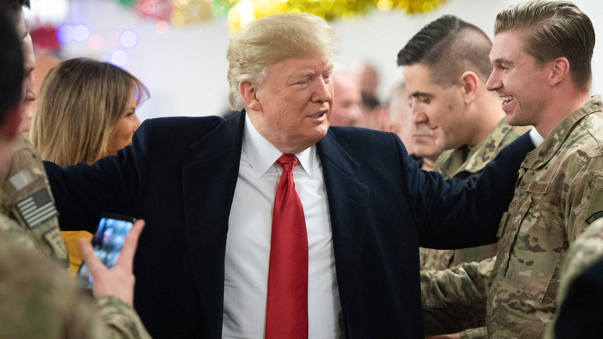 US President Donald Trump and First Lady Melania Trump greet members of the US military during an unannounced trip to Al Asad Air Base in Iraq on December 26, 2018