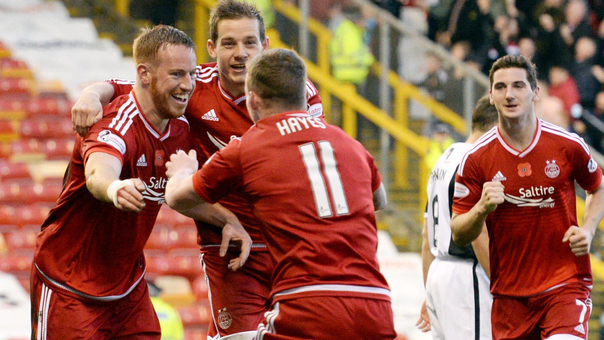 The Aberdeen players congratulate scorer Adam Rooney