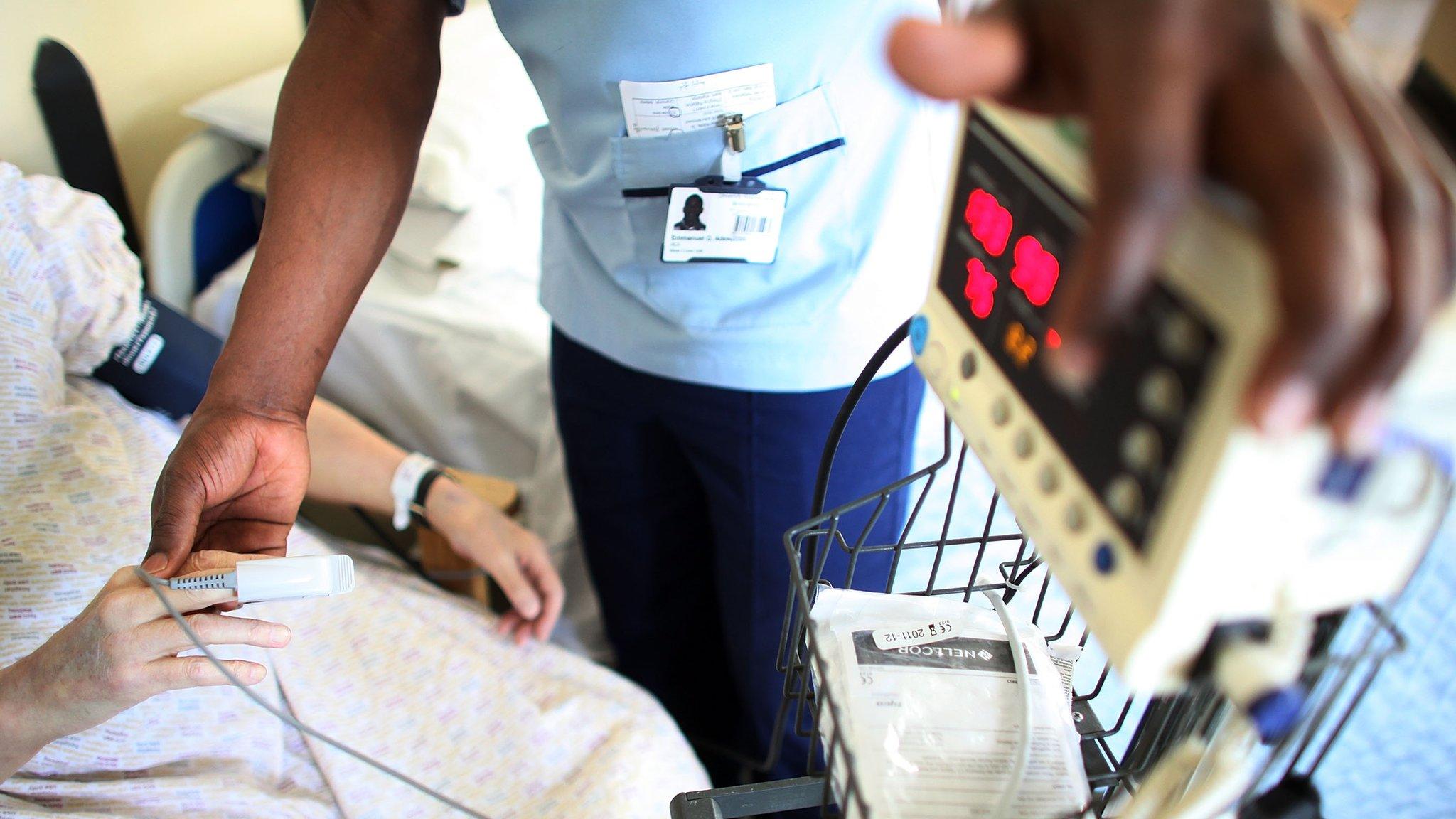 A nurse looks after a patient