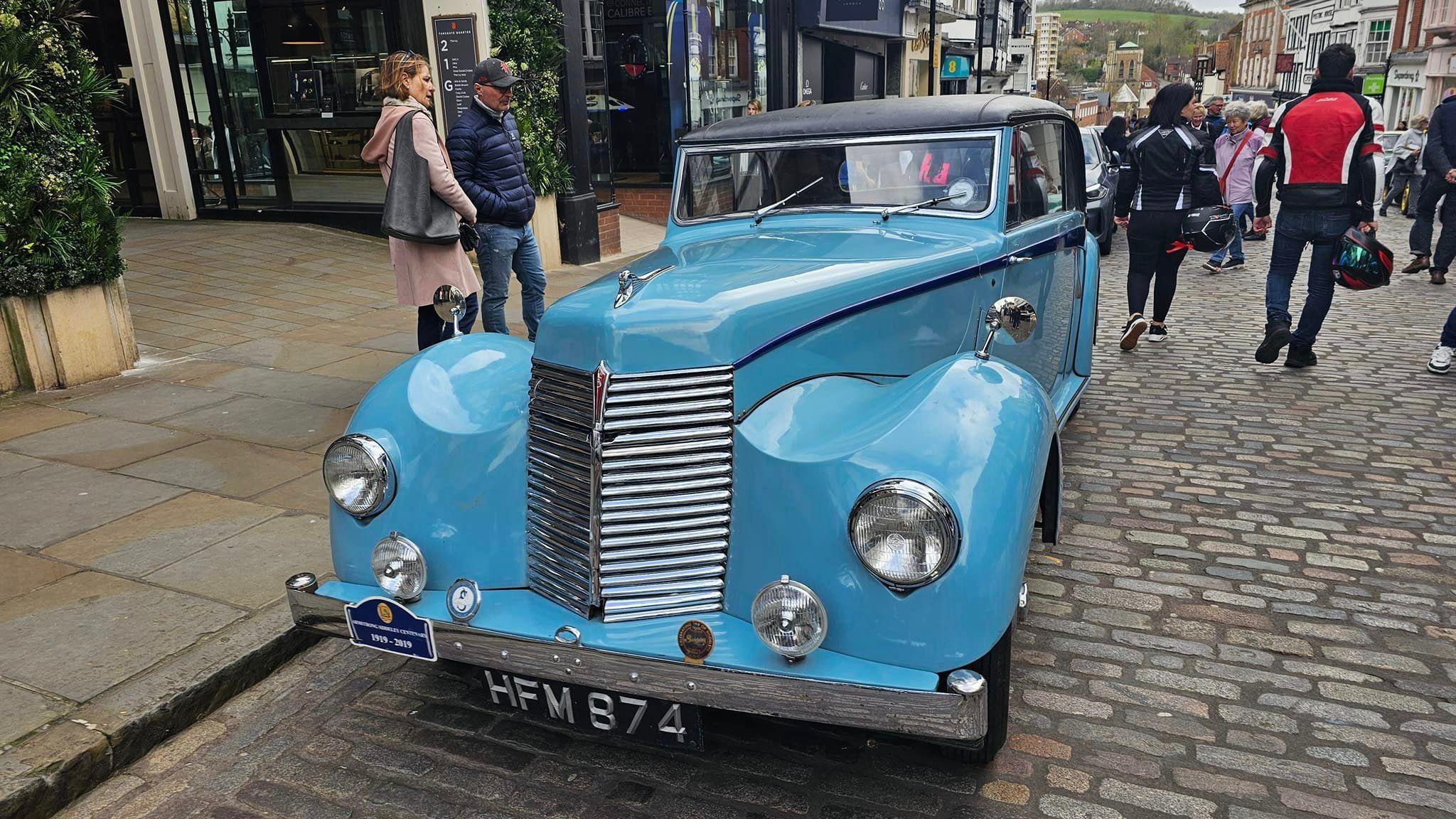 A blue vintage car parked on Guildford High Street