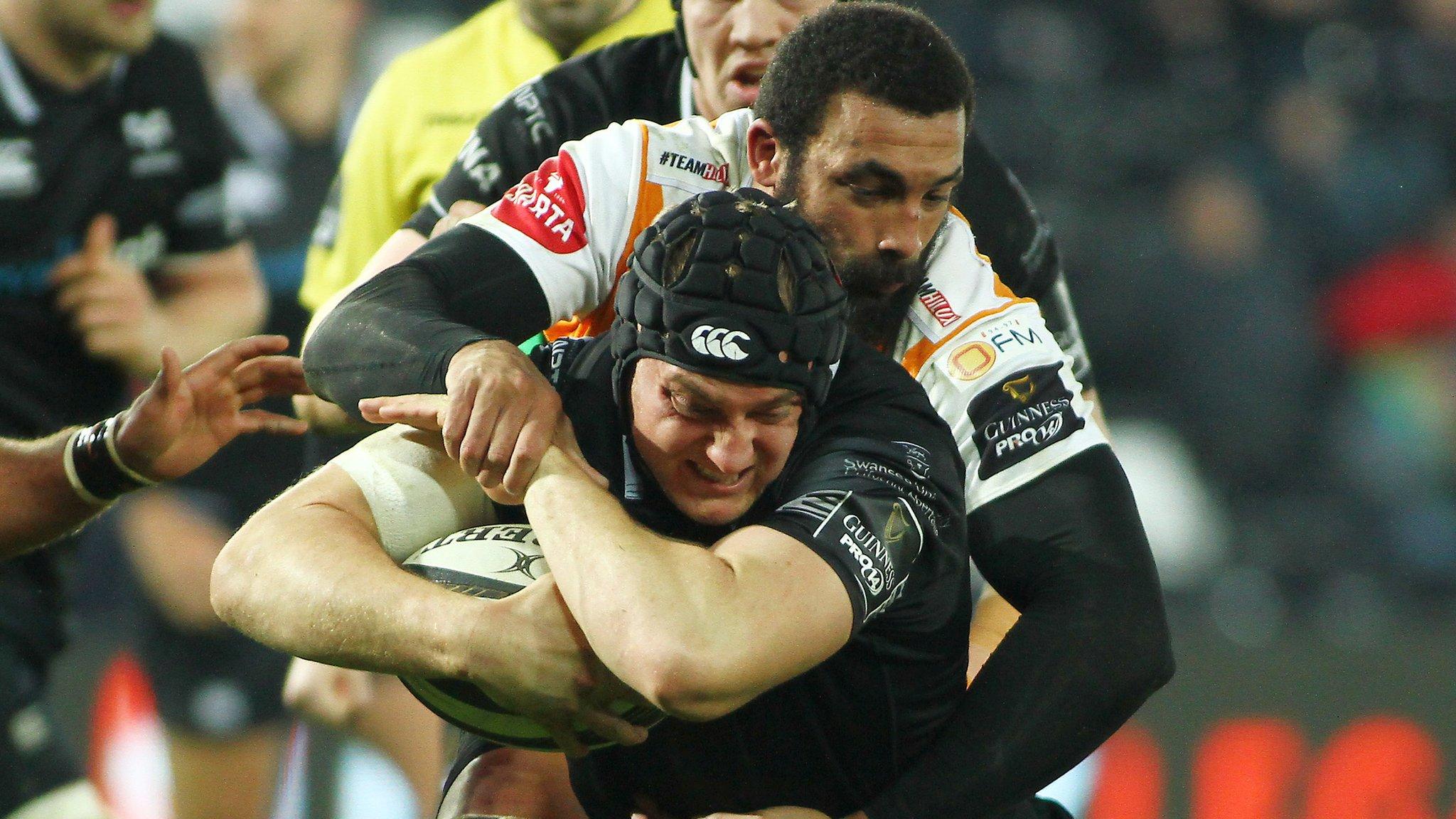James King of Ospreys is tackled by Uzair Cassiem of Cheetahs