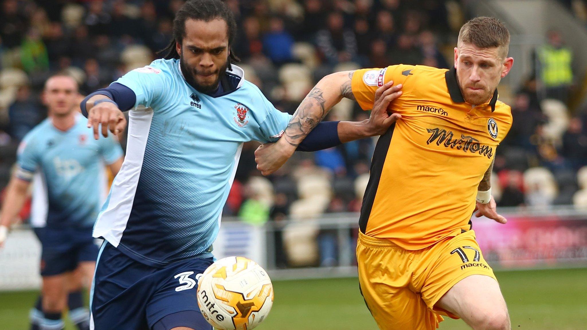 Scott Bennett in action against Nathan Delfouneso