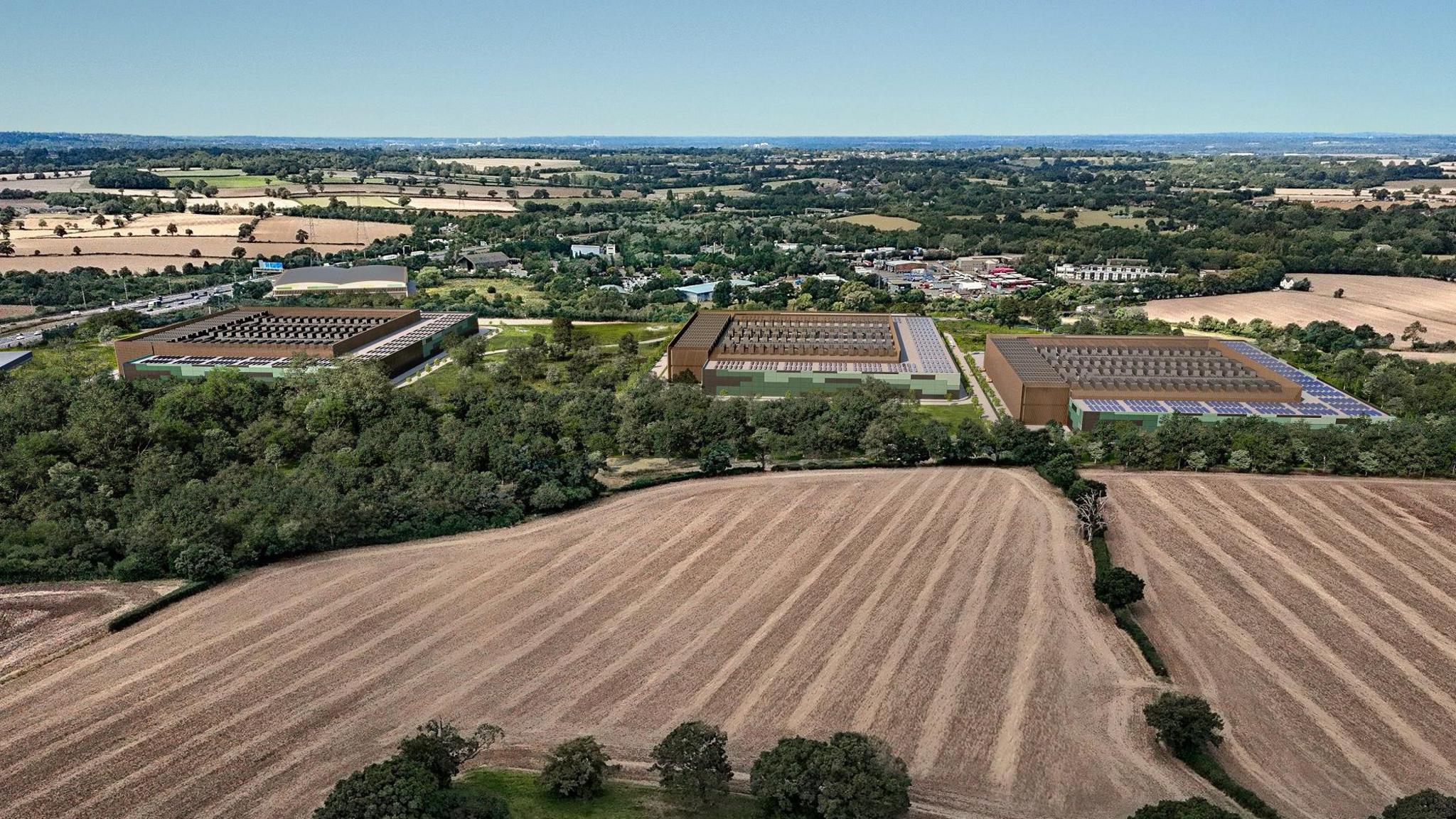 An artist's impression depicting an aerial view, this time from further away and showing how the new buildings will look next to a large field