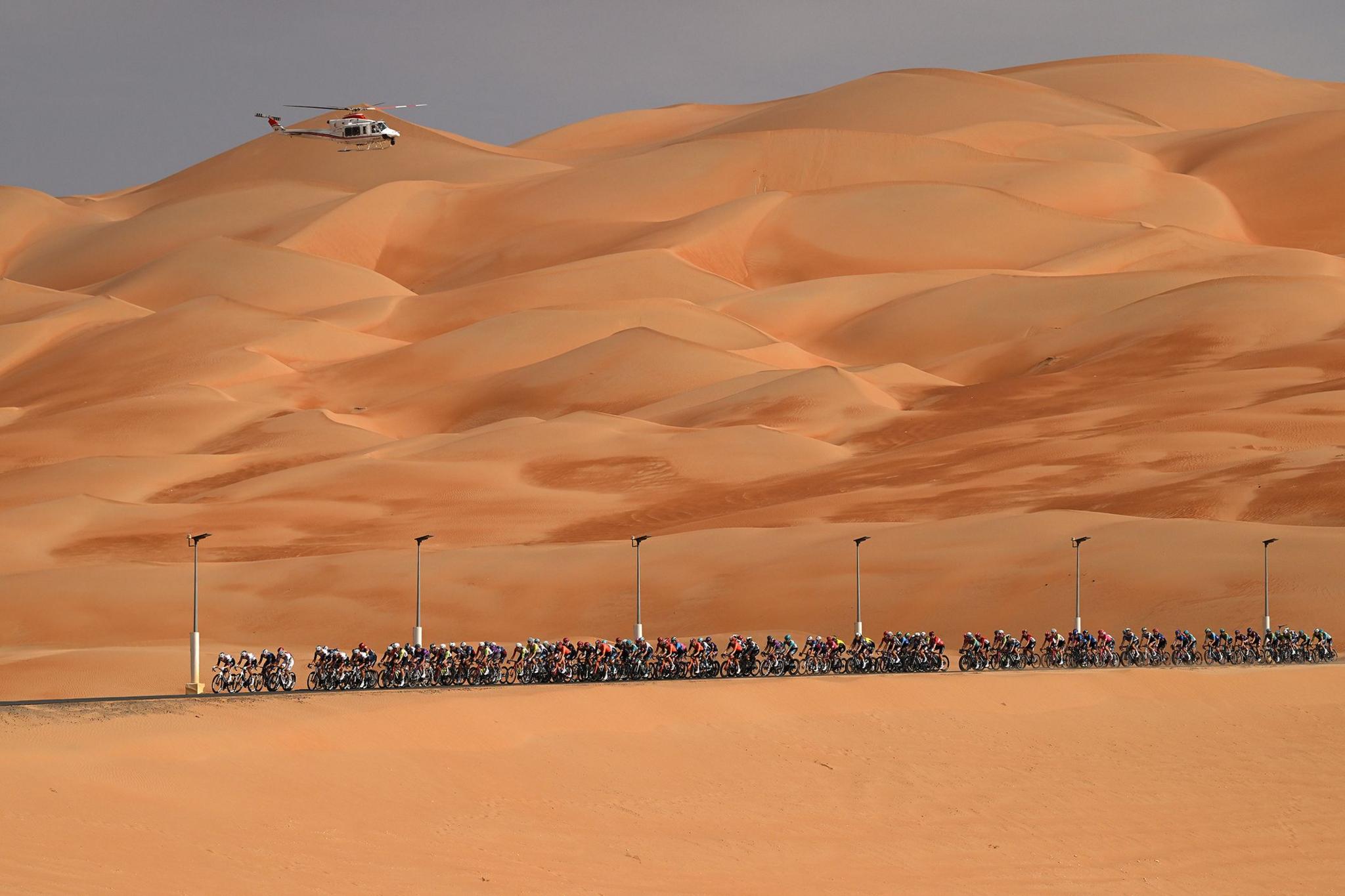 A helicopter hovers above the peloton during cycling's UAE Tour