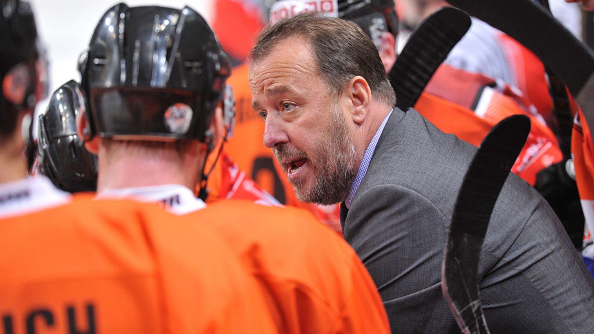 Paul Thompson talks with players on the Sheffield Steelers bench