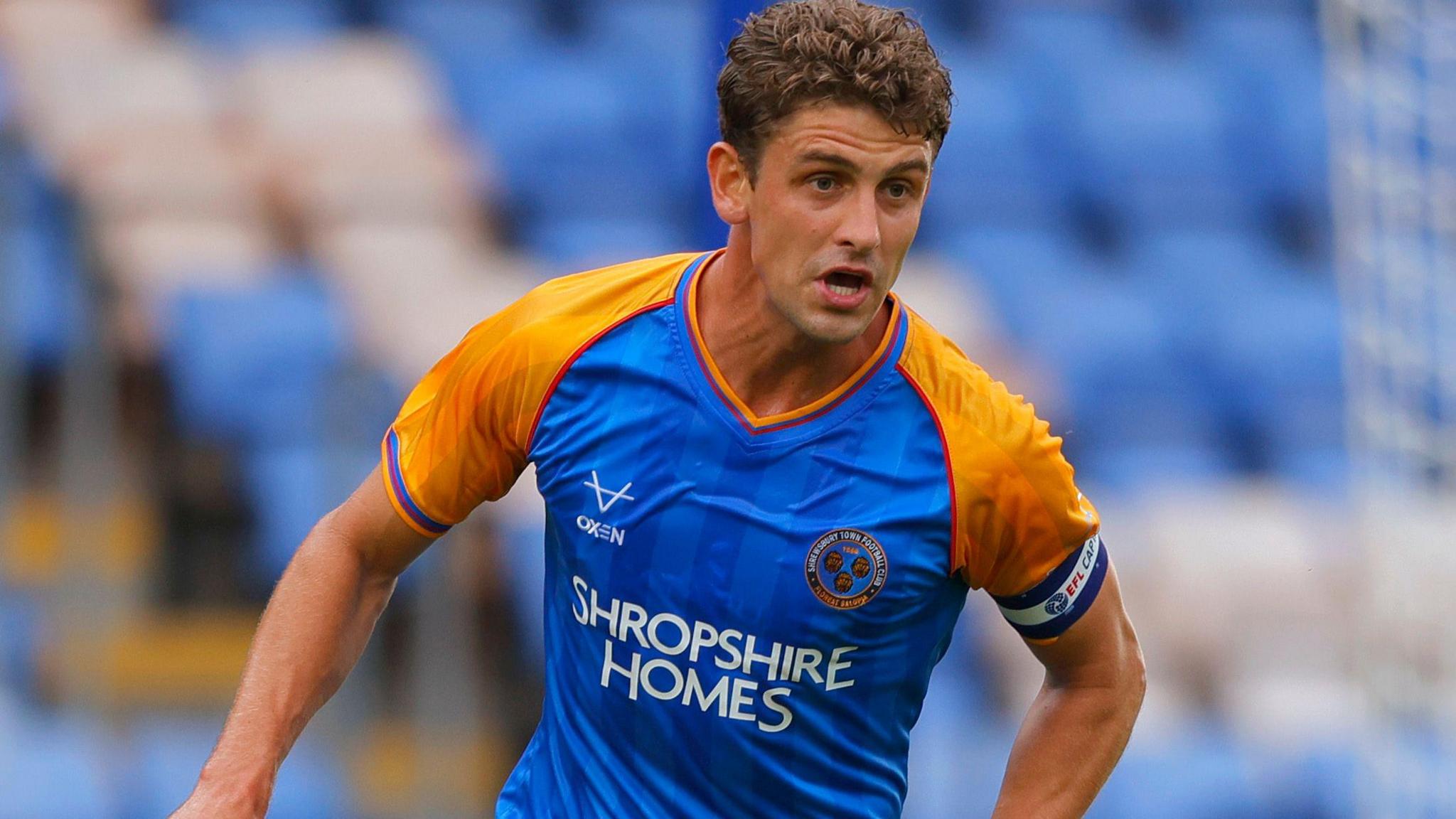 Harrison Biggins of Shrewsbury Town runs with the ball during