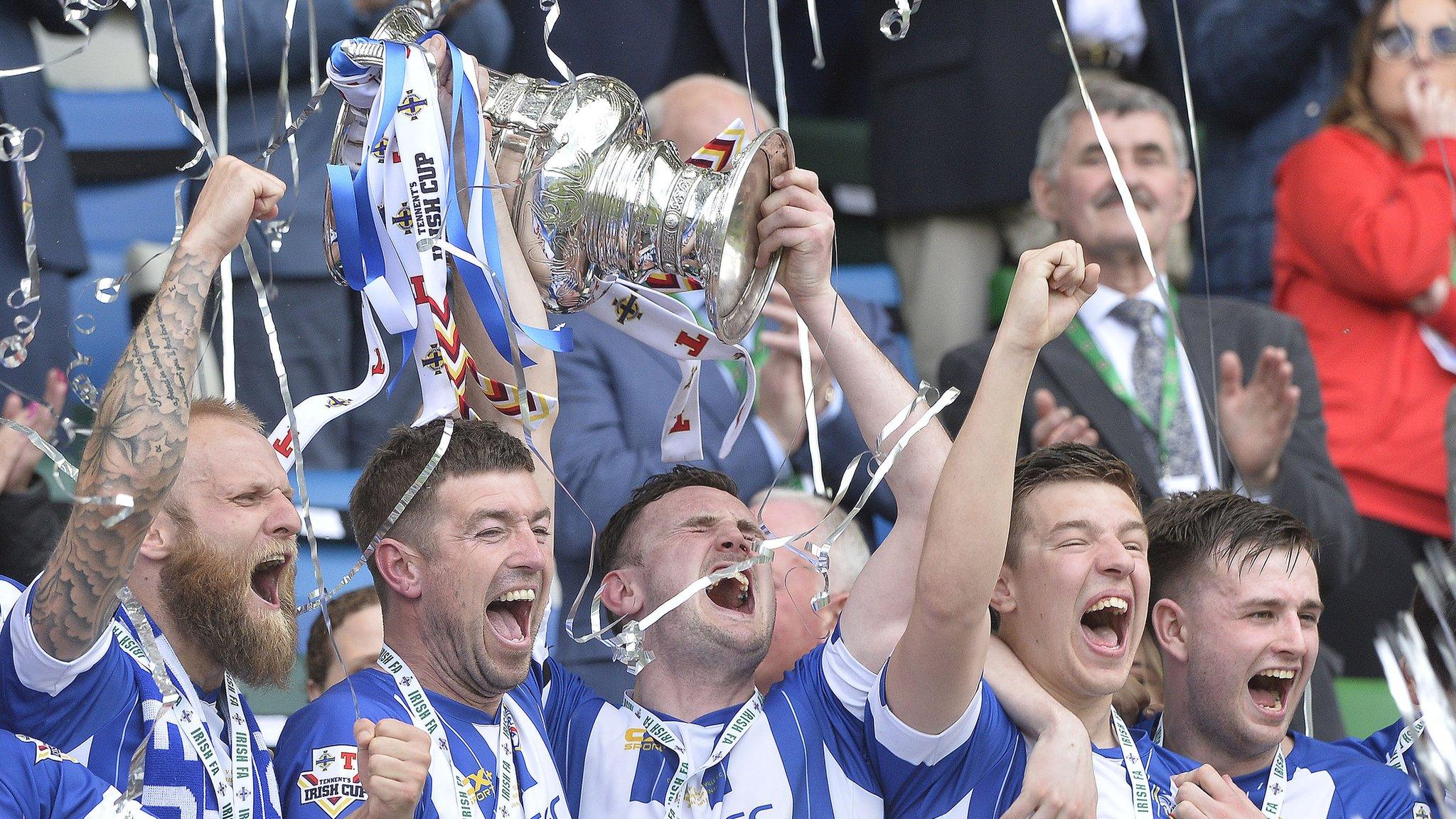 Coleraine players celebrate as captain Stephen O'Donnell holds the Irish Cup aloft