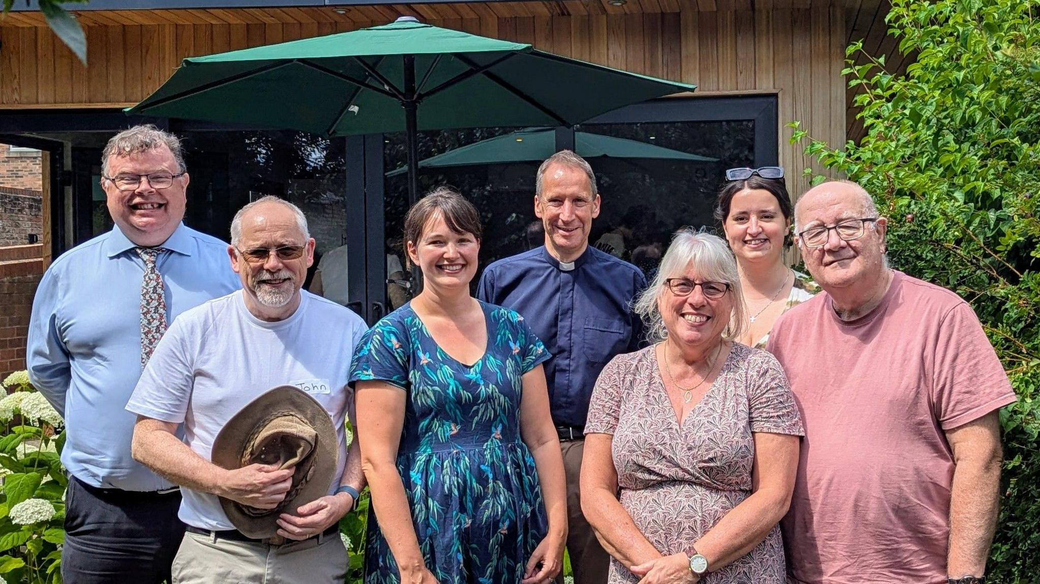 Seven people stand outside a church. From the left to right of the picture is Cllr Andrew Waller, Rev John Hayward, Fran Taylor, Rev Leslie Newton, Angie Crewsick, Naomi Prince, Robin Taylor.