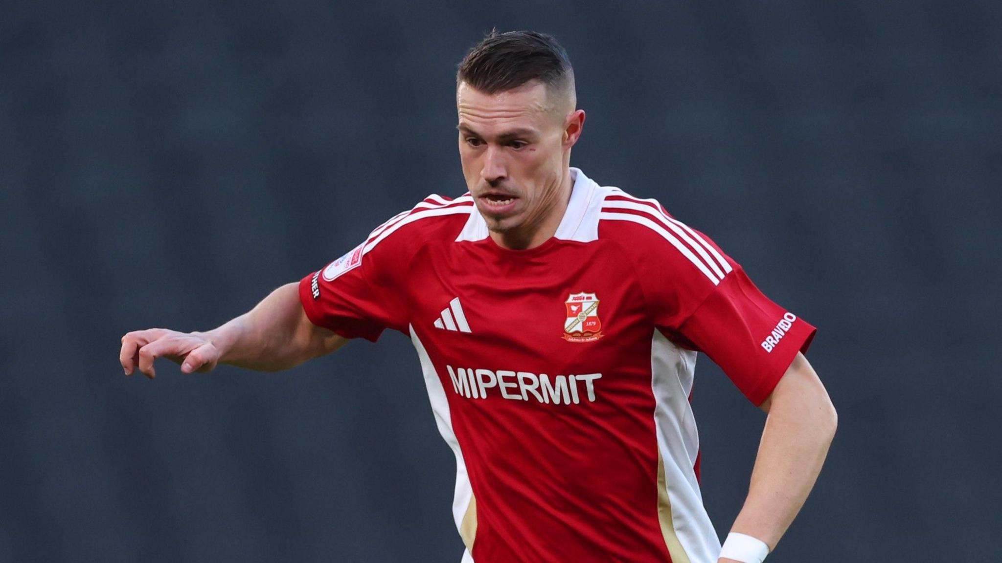 Swindon Town forward Billy Bodin wearing a red home shirt during an EFL football match