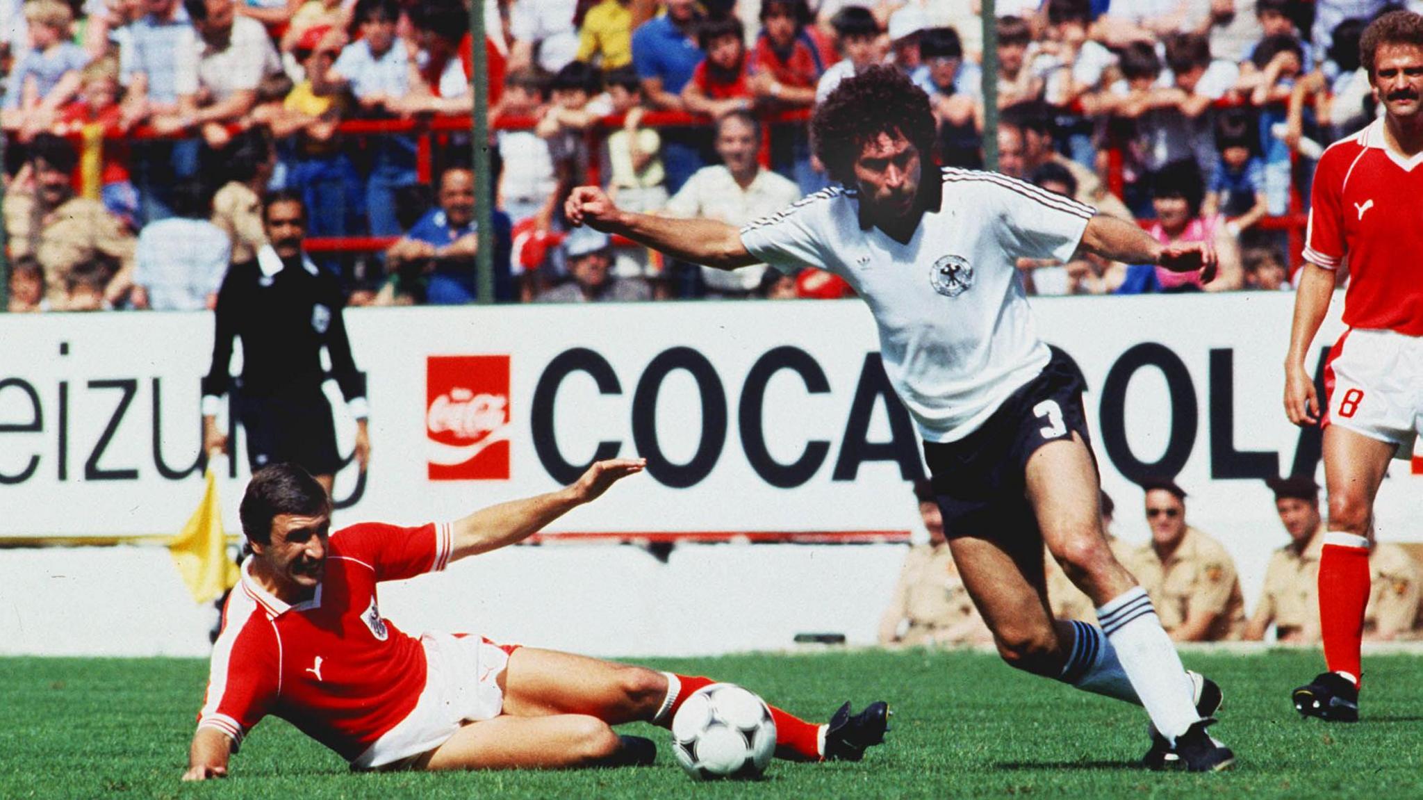 West Germany's Paul Breitner dribbles past Hans Krankl of Austria at the World Cup in 1982