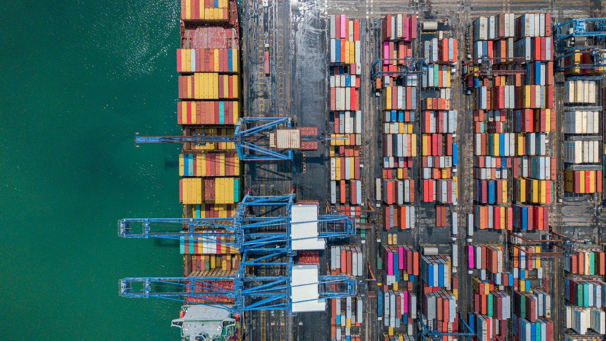 Coloured cargo containers at a port.