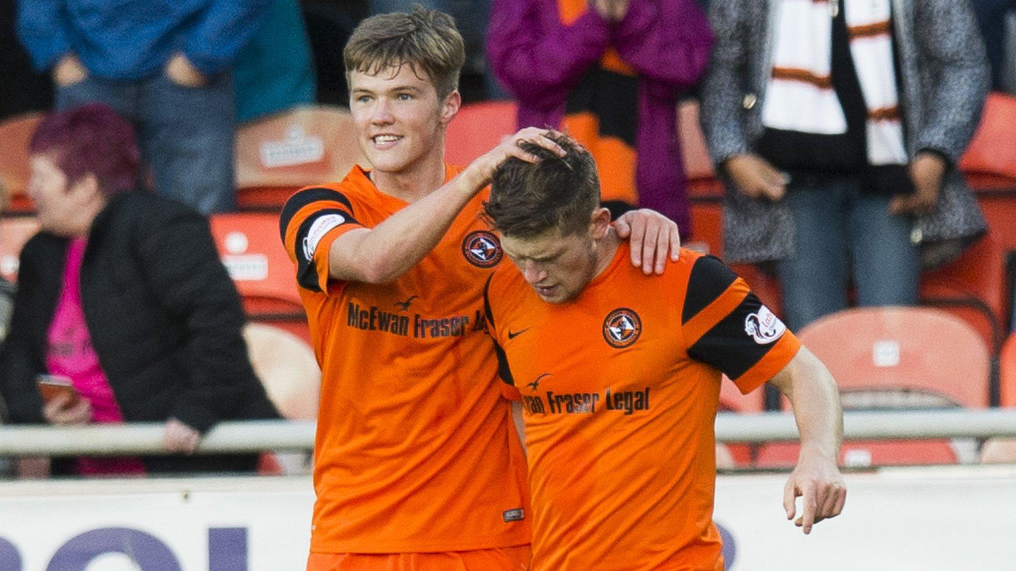 Blair Spittal congratulates Cammy Smith on his hat-trick goal for Dundee United