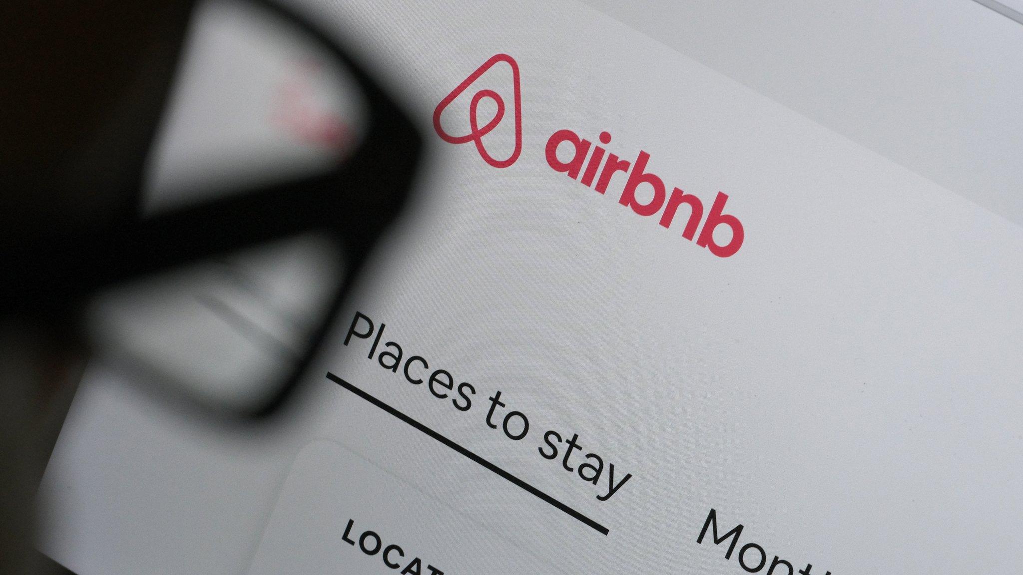 photo illustration of man looking at airbnb website