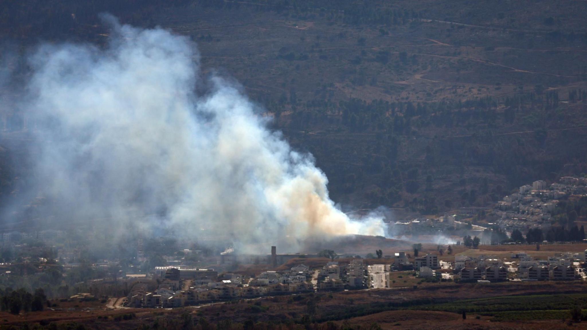 Smoke rises from land near the northern Israeli town of Kiryat Shmona following a Hezbollah rocket attack (3 July 2024)