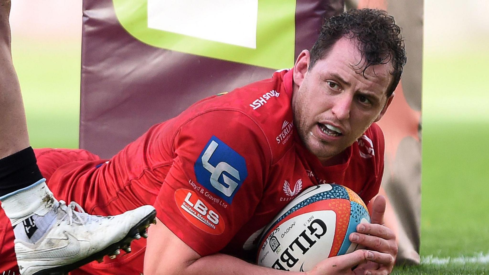 Hooker Ryan Elias on the ground with the ball after scoring a try for Scarlets