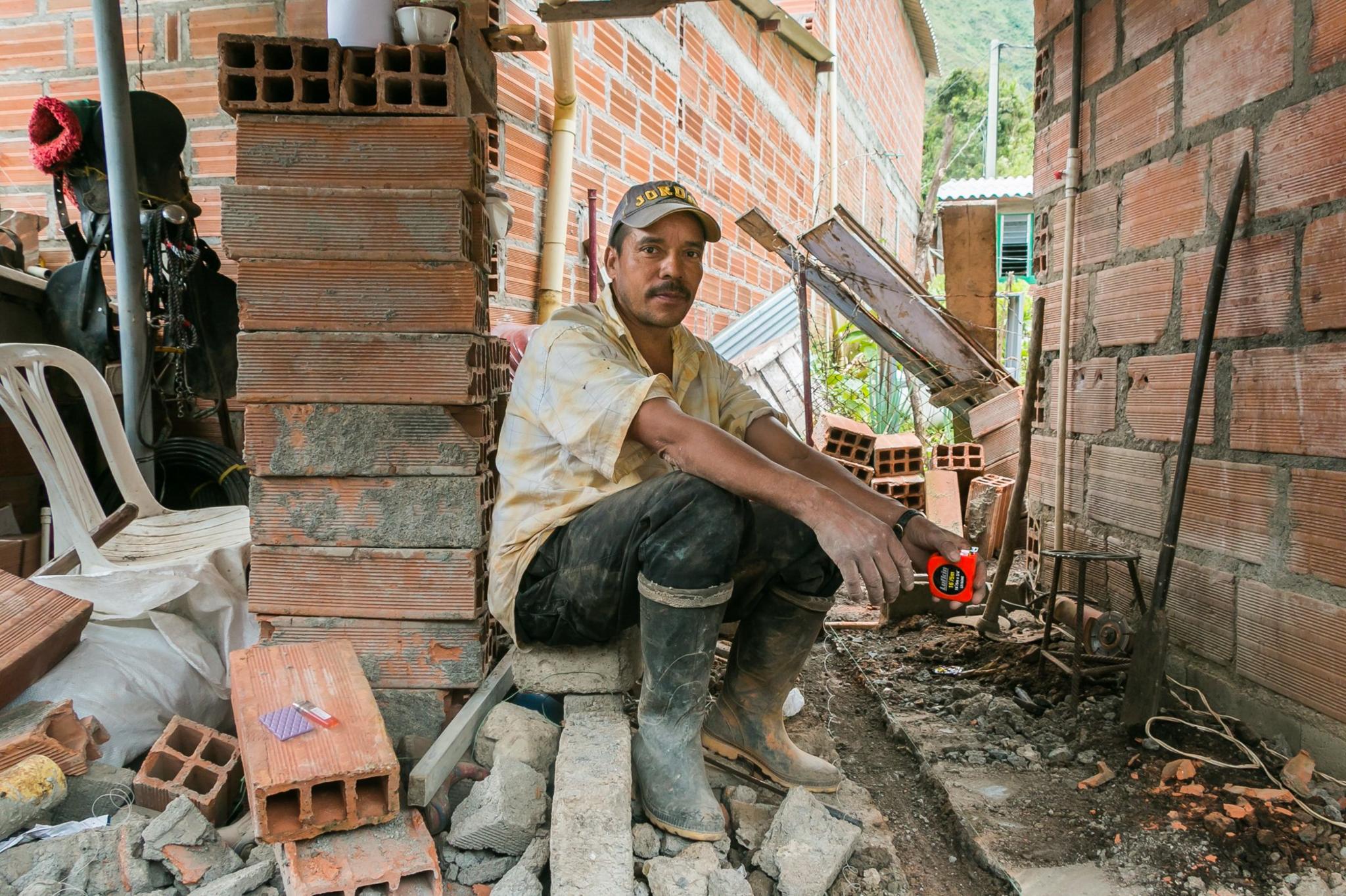 A man sits at a building site in Santa Lucia in July 2016.