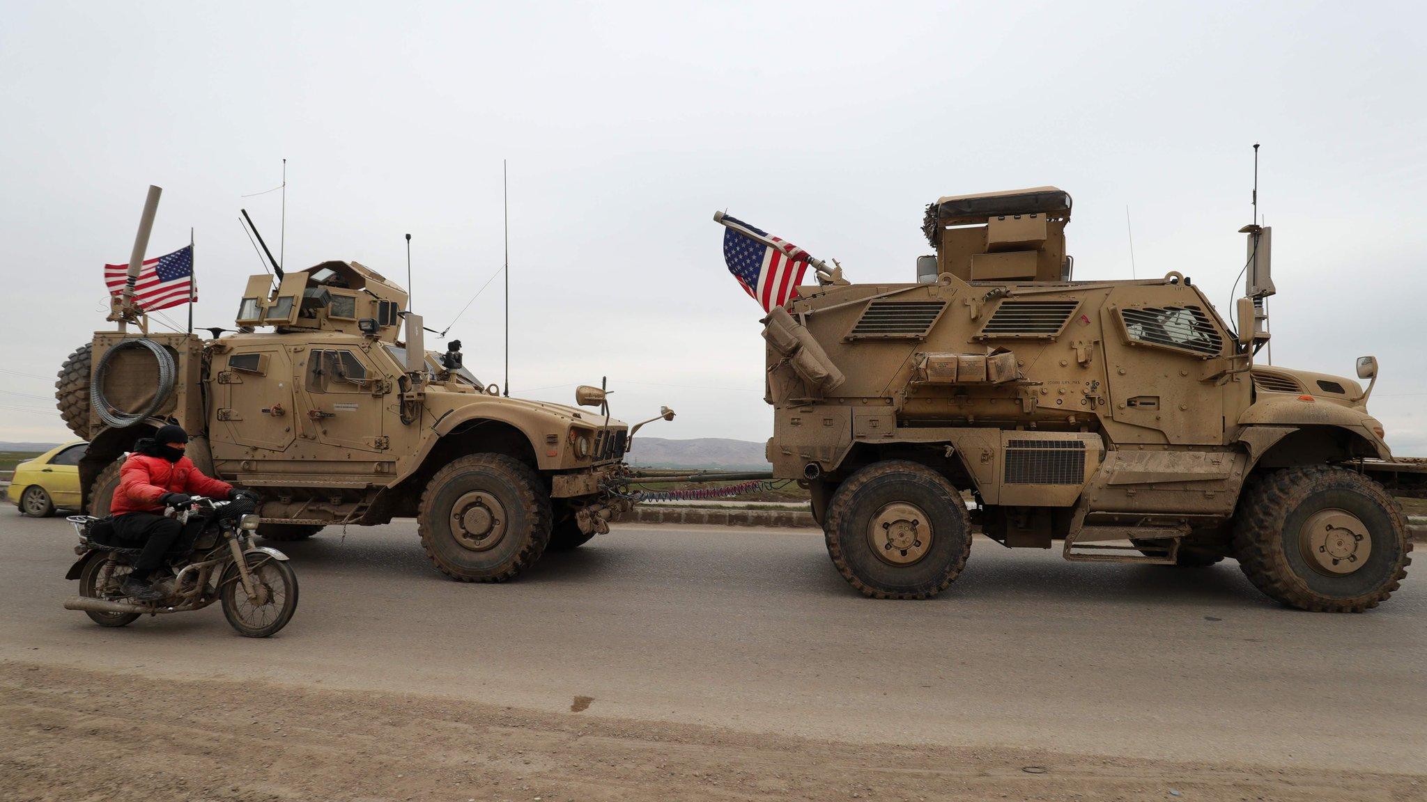 A US military vehicle tows another vehicle on the outskirts of the Syrian city of Qamishli on 12 February 2020