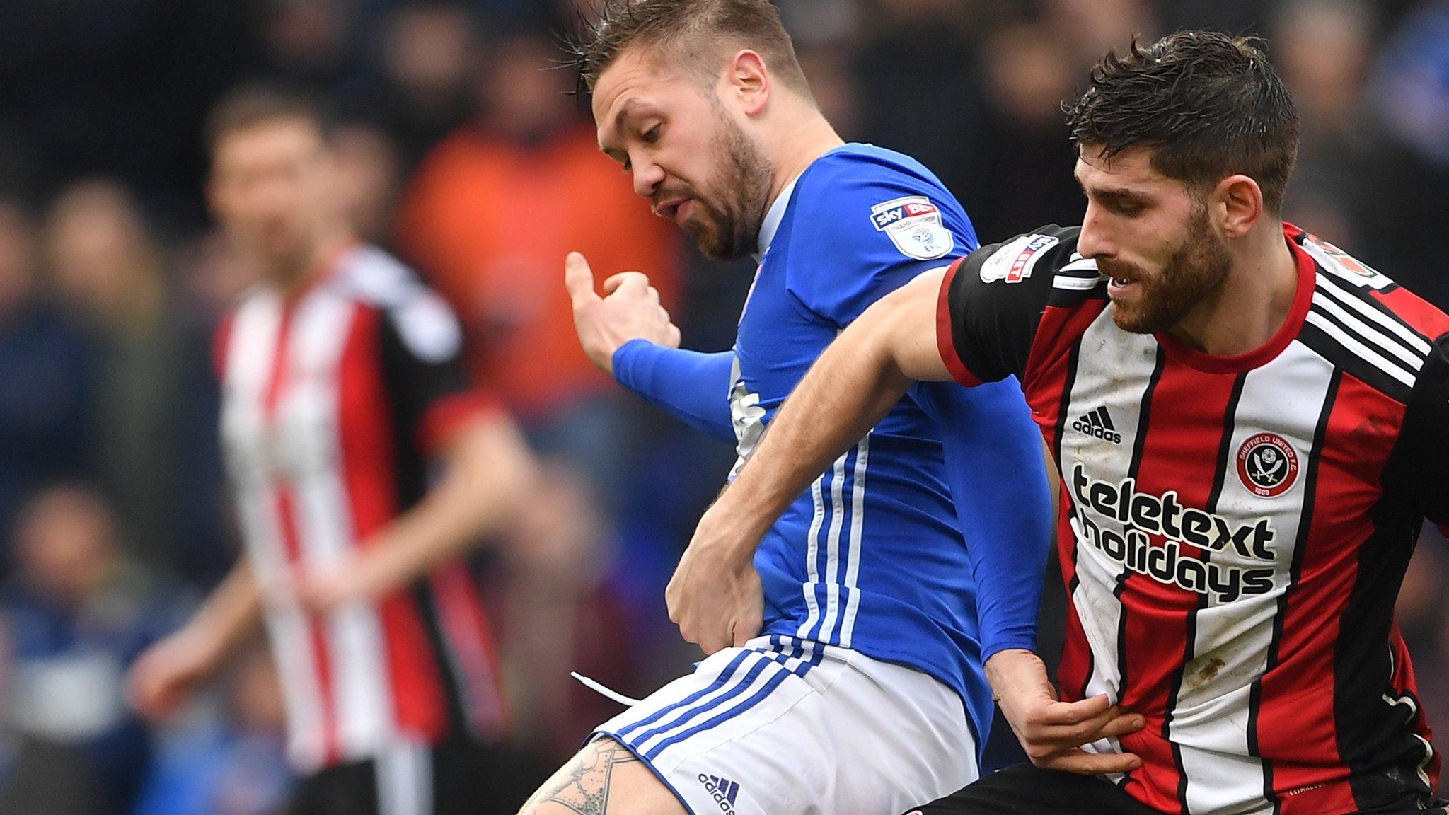 Ipswich Town's Luke Chambers (left) and Sheffield United's Ched Evans battle for the ball