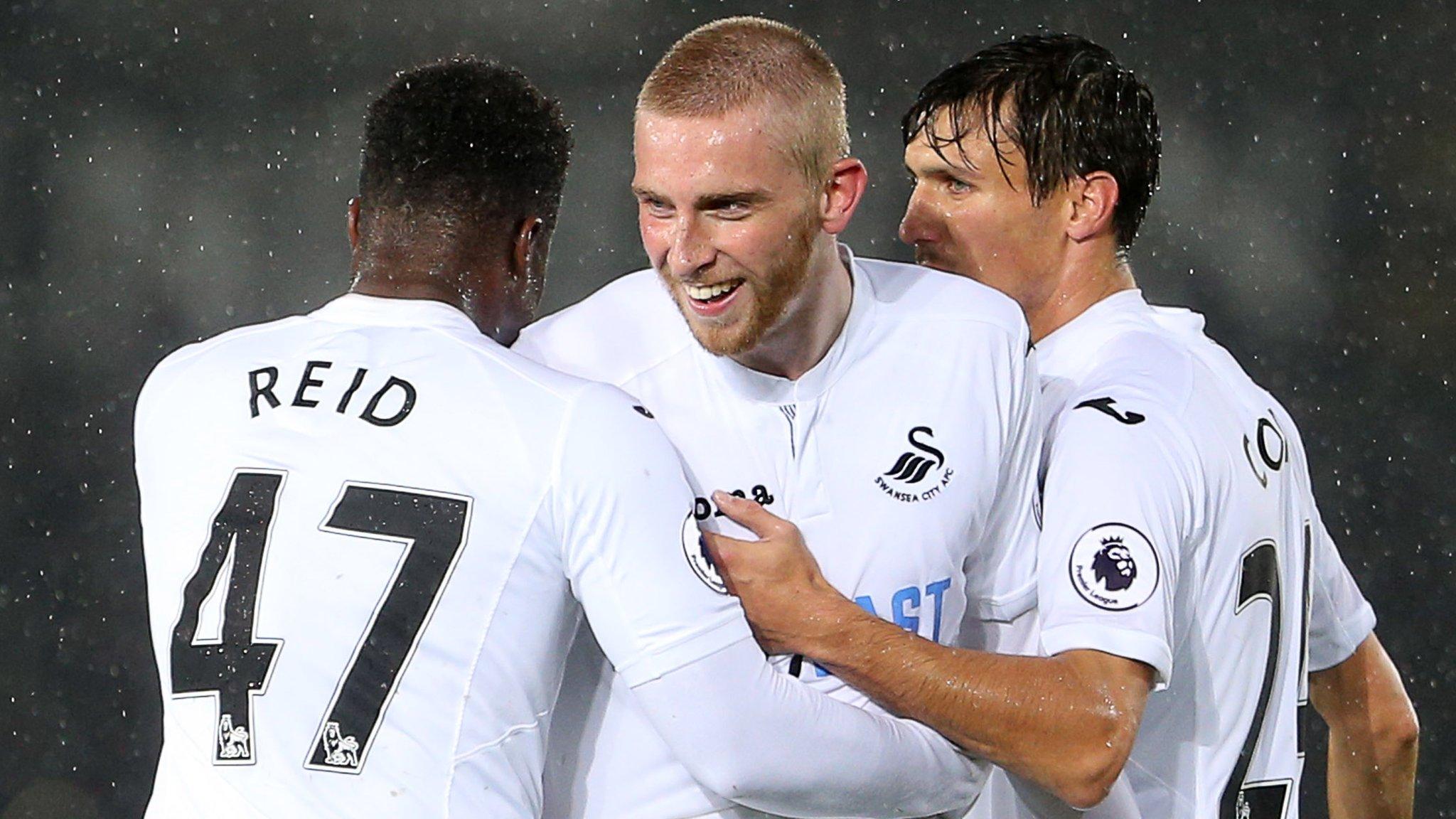 Oliver McBurnie of Swansea City celebrates with Tyler Reid and Jack Cork