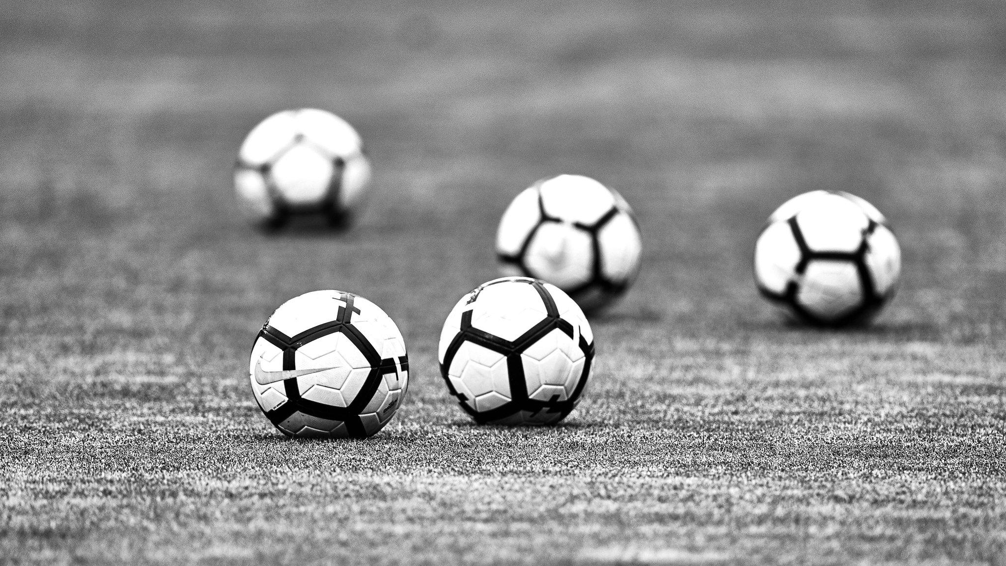 Footballs on a pitch