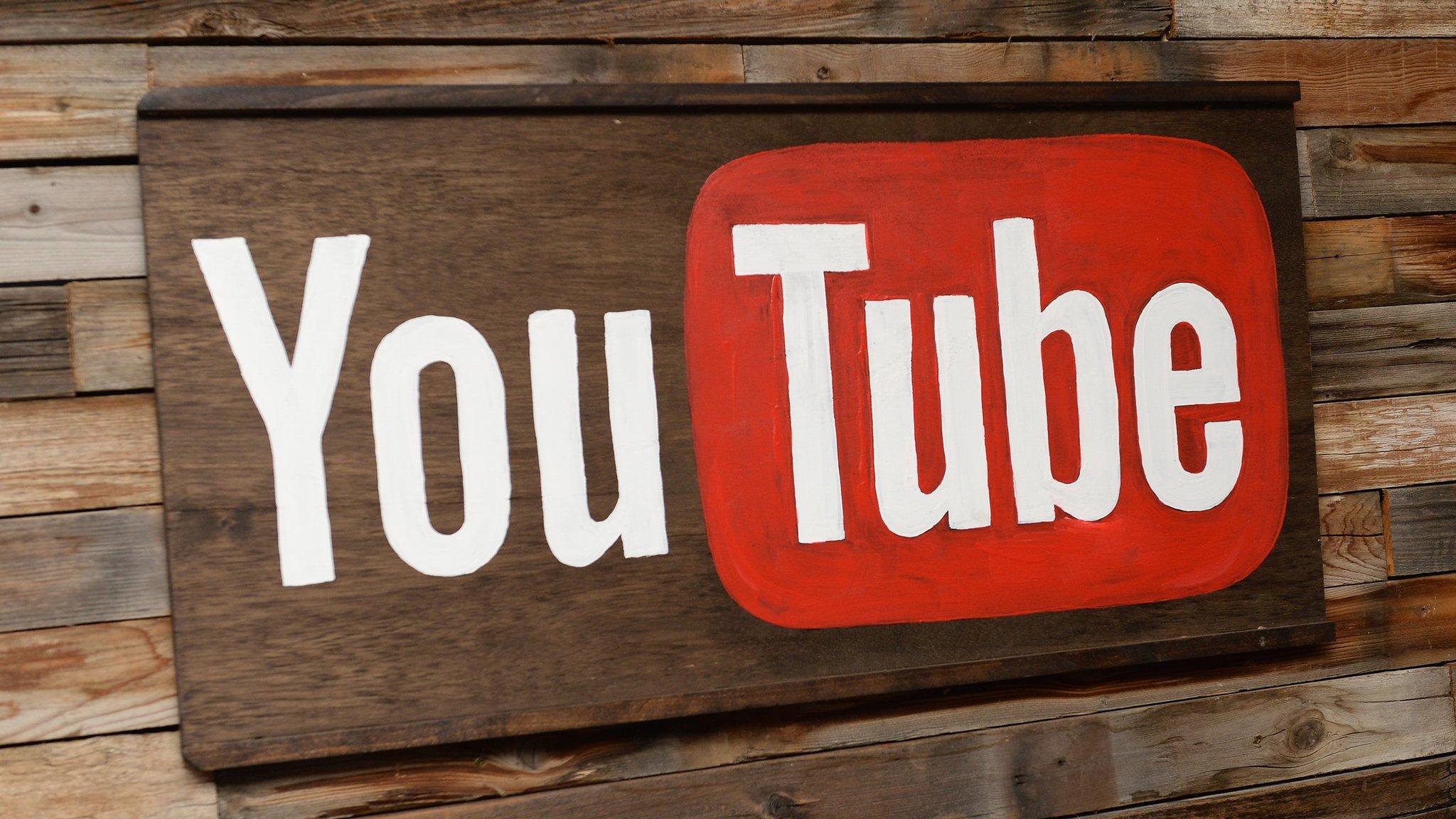 YouTube logo on wooden board