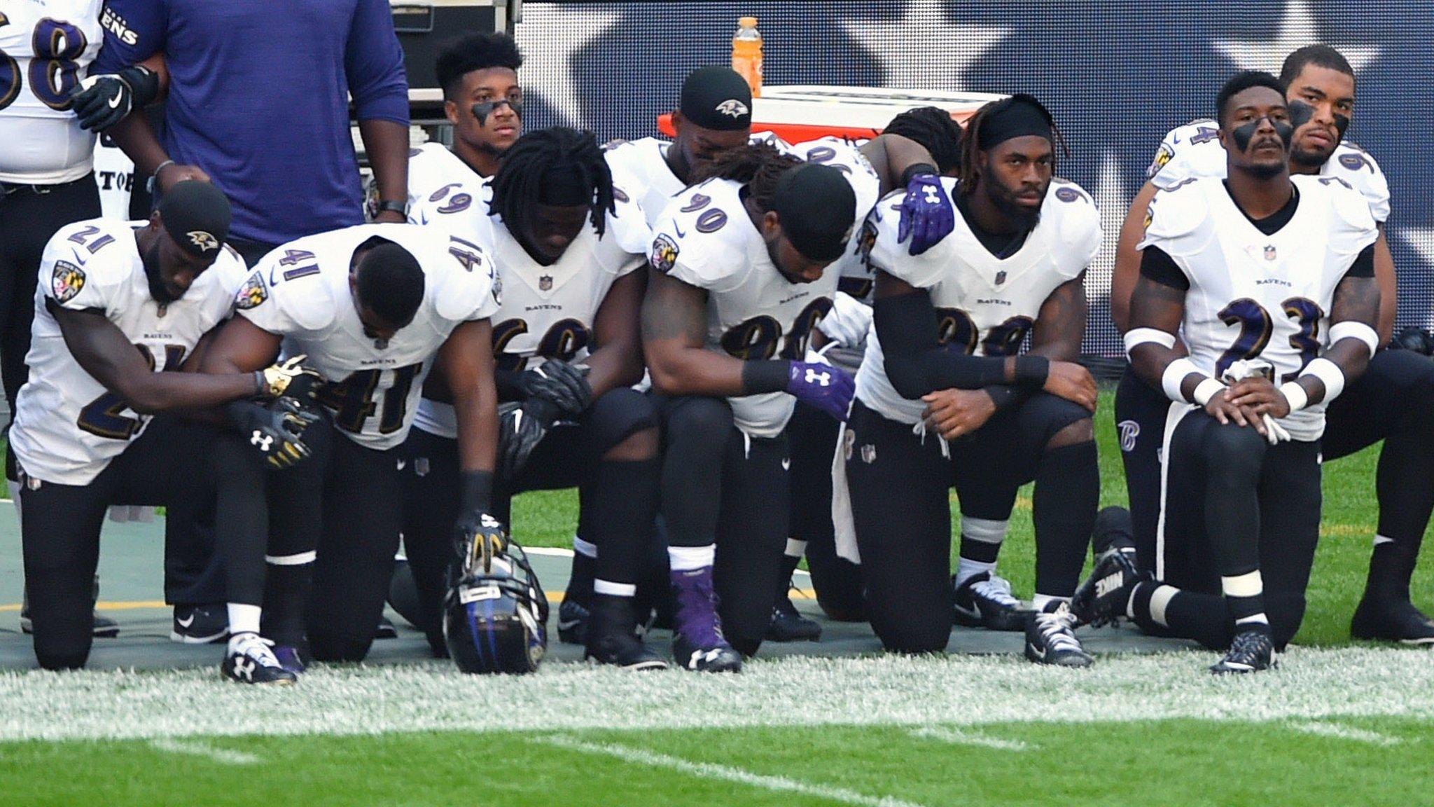 Baltimore Ravens players kneel during the national anthem at Wembley