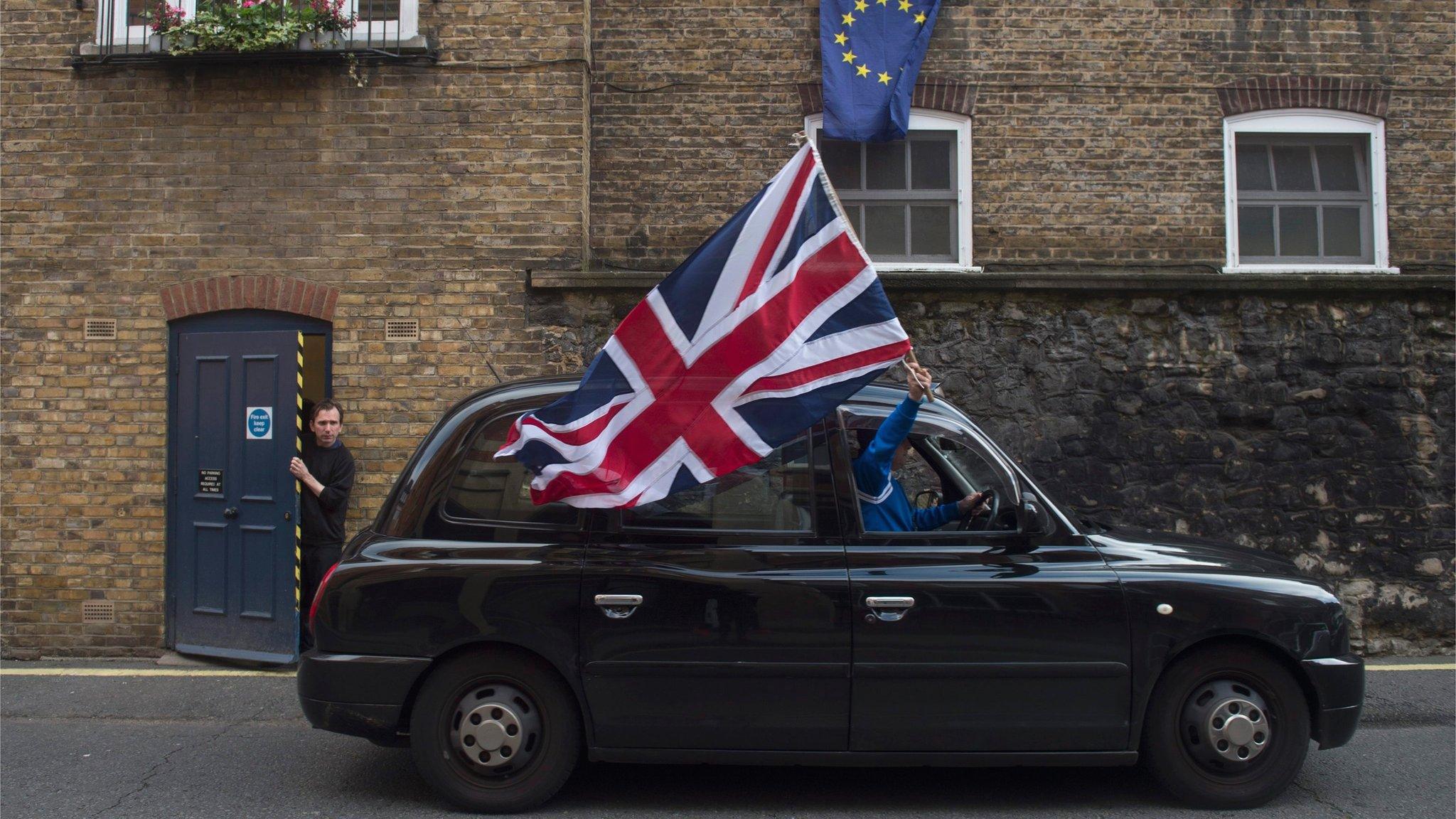 Black cab driver with union jack flag