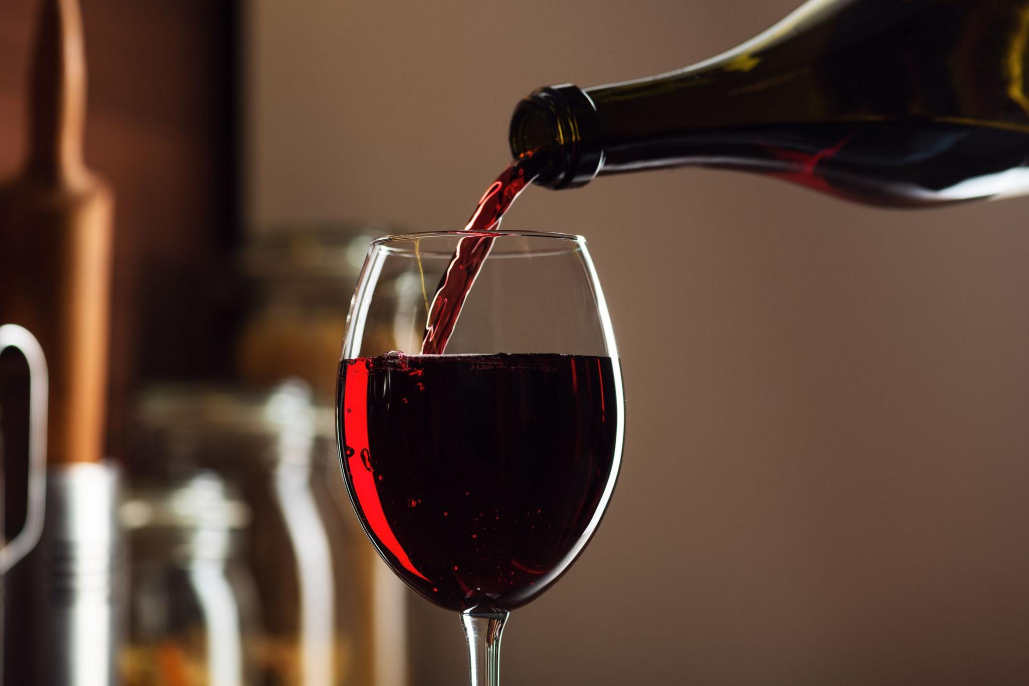 Red wine being poured into a wine glass