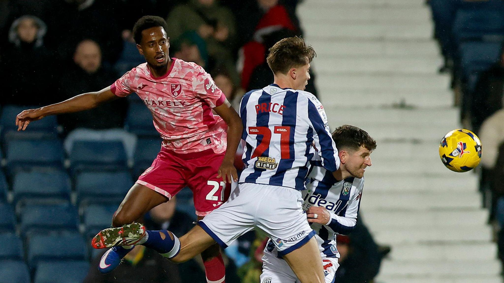 Norwich City's Ali Ahmed and Isaac Price of West Brom jump in the air to compete for the ball in the match at the Hawthorns. 