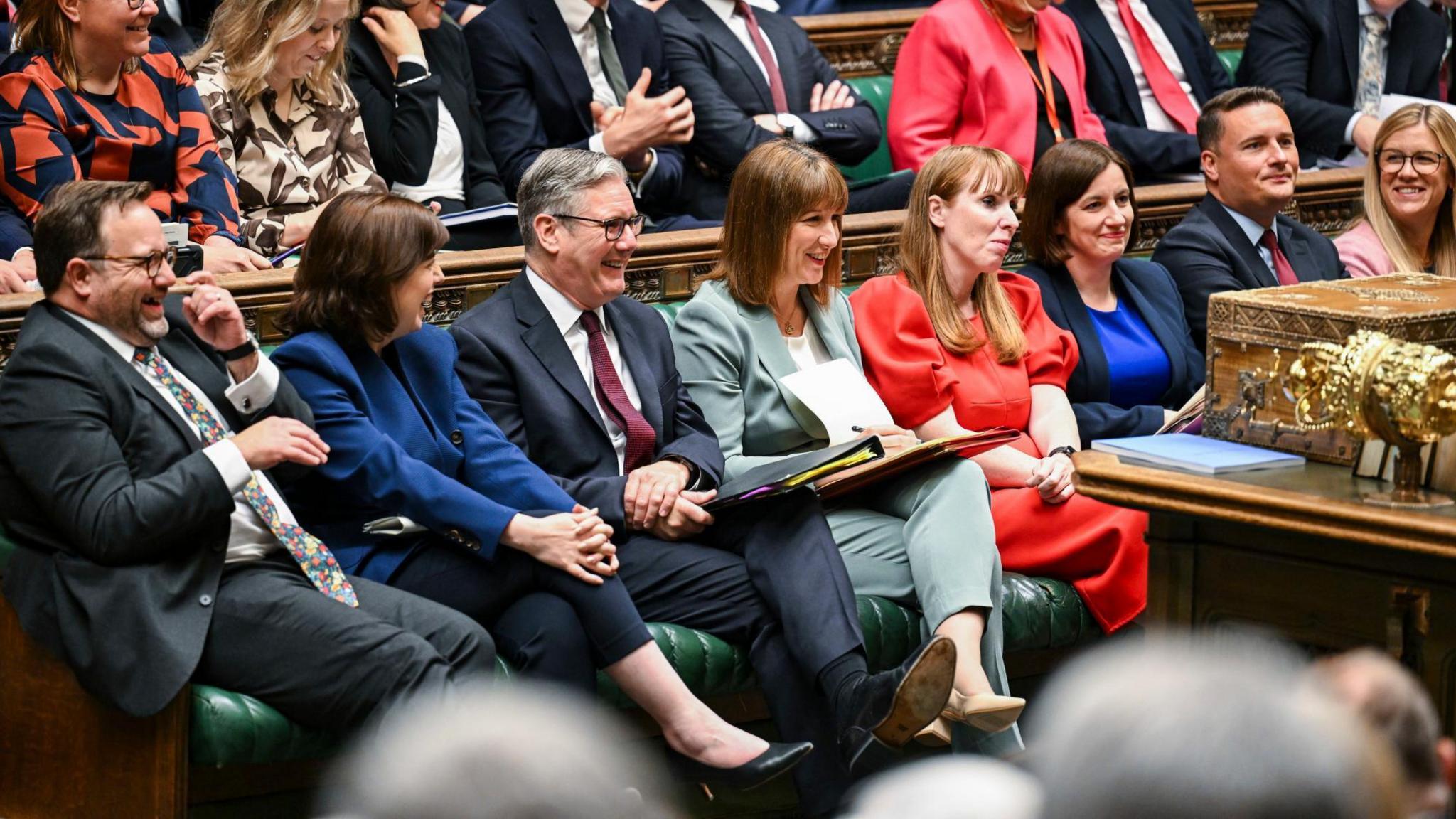 The government front bench sit in the House of Commons.
