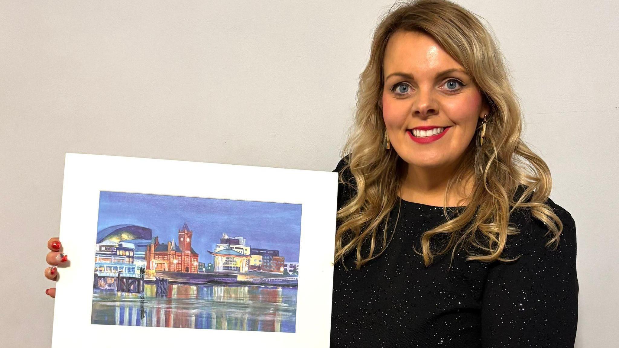 Ms Rasmussen poses with the image of Cardiff Bay