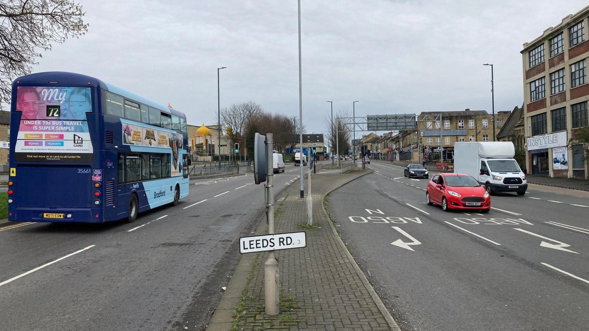 Buses and cars driving up Leeds Road in Bradford