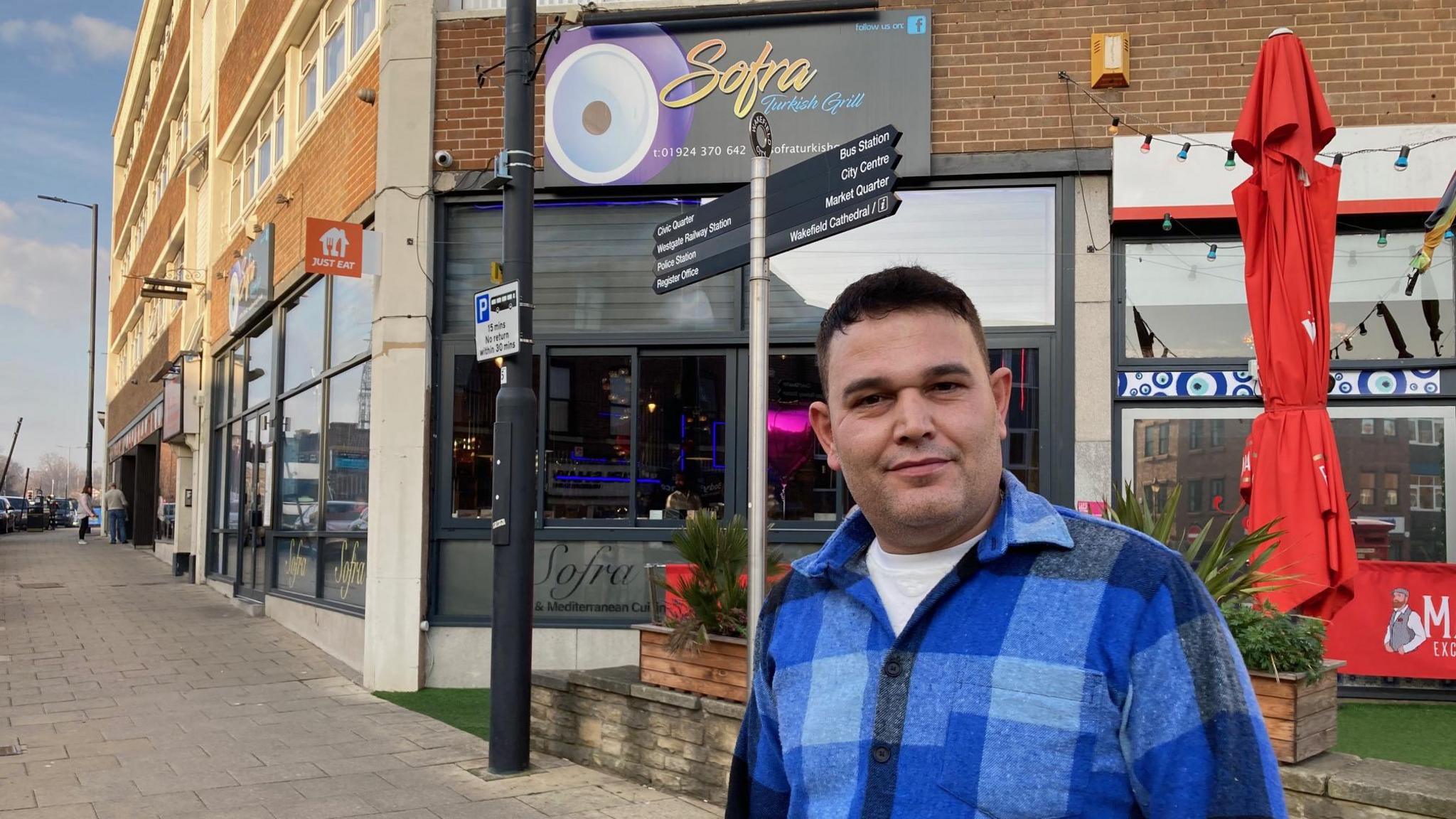 Hakan Kalkan outside his business