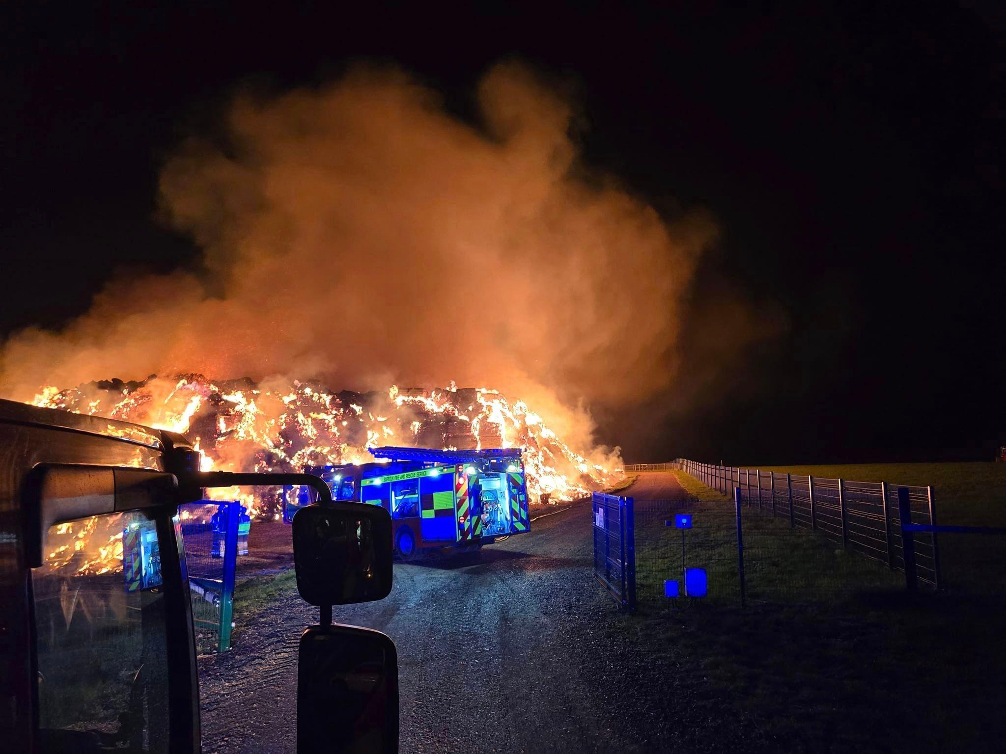 Blazing stack of straw at night