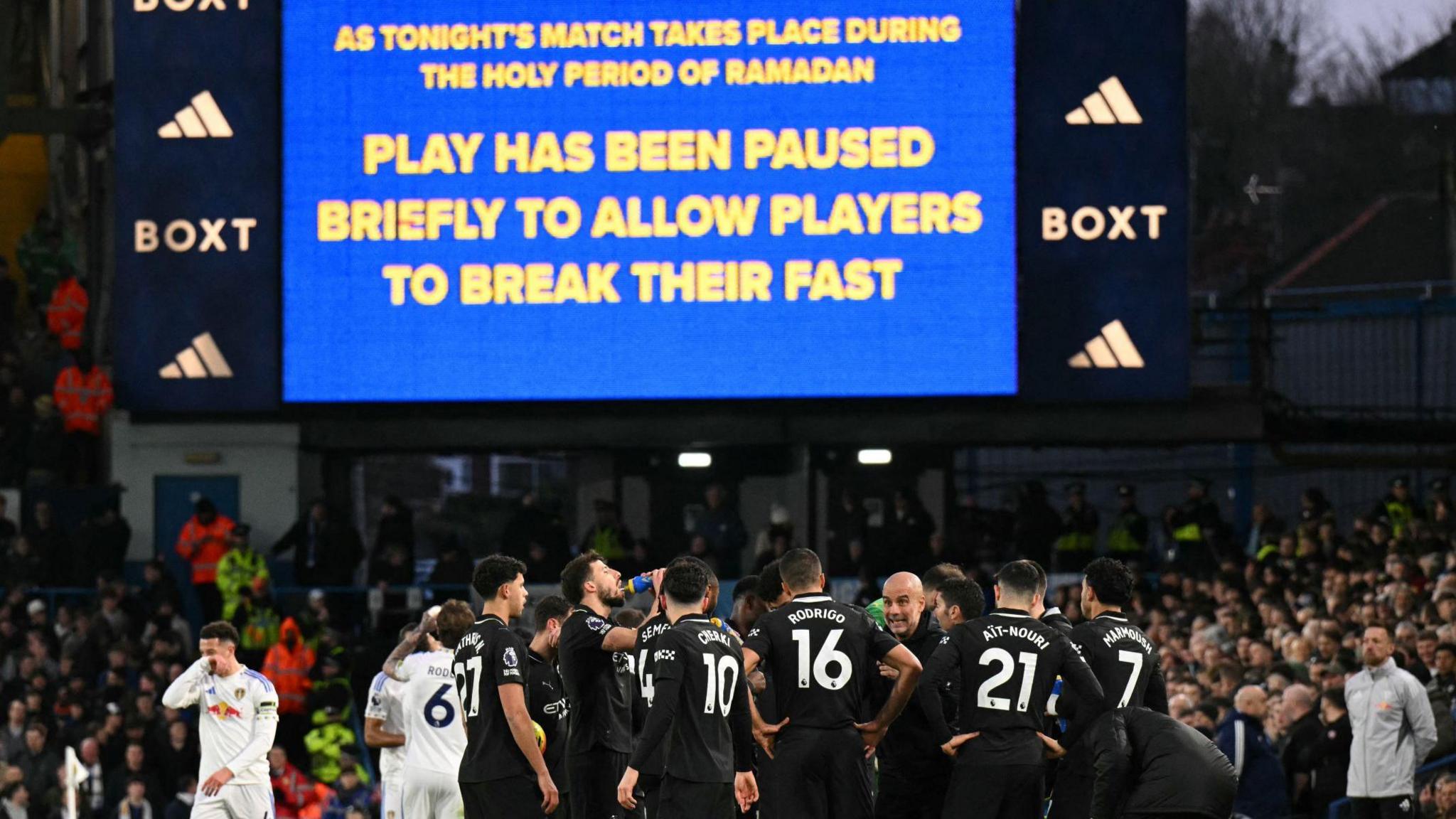 The big screen at Elland Road displays a message explaining that the game against Manchester City will be stopped to allow players to break their fast to take on water and energy as they observe Ramadan