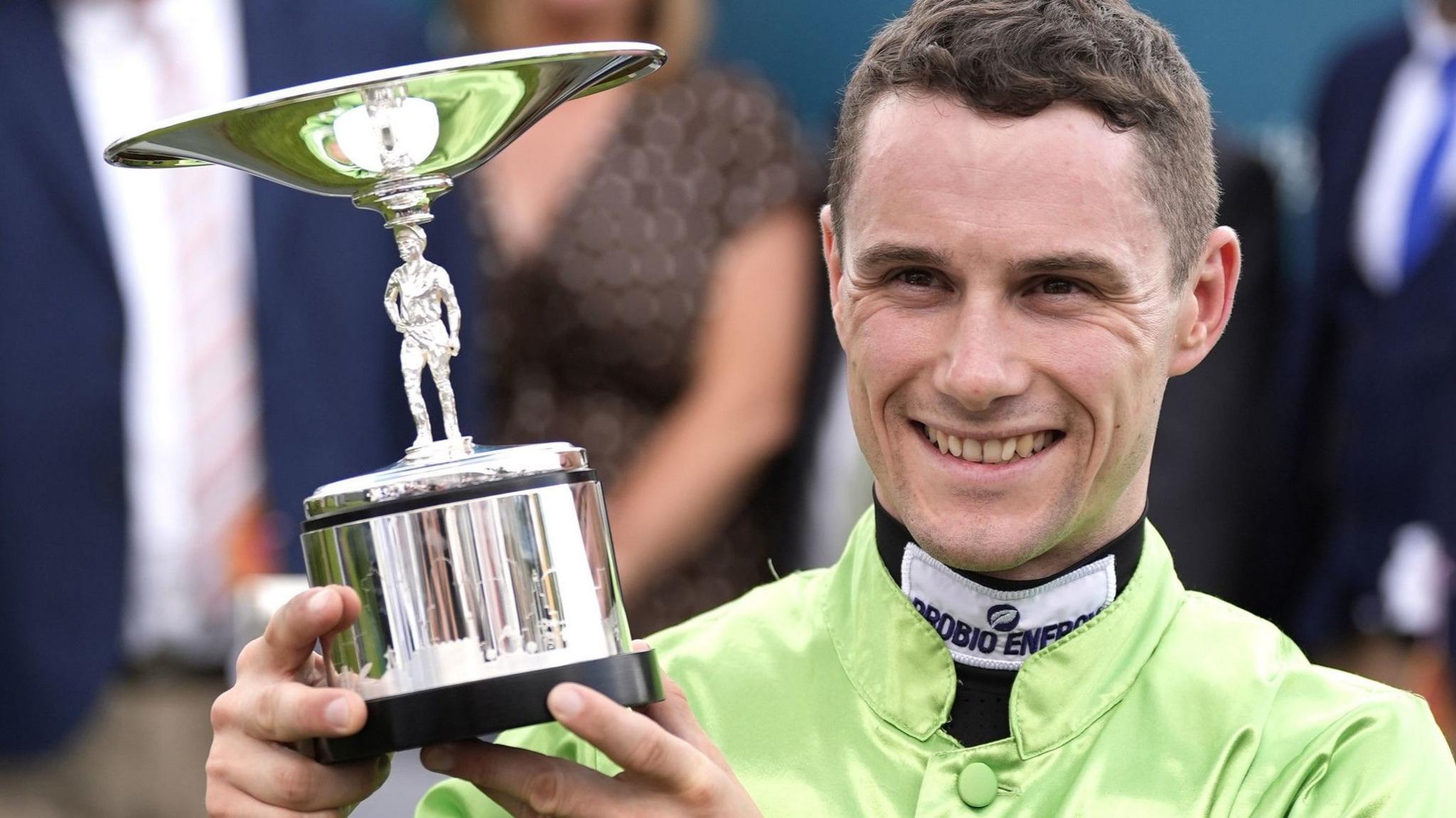 Jockey Jason Hart with the trophy after JM Jungle won at Glorious Goodwood