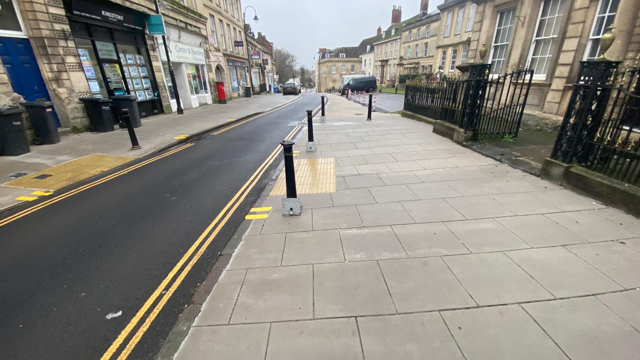 A view of a newly laid and marked cycle path through a town centre area